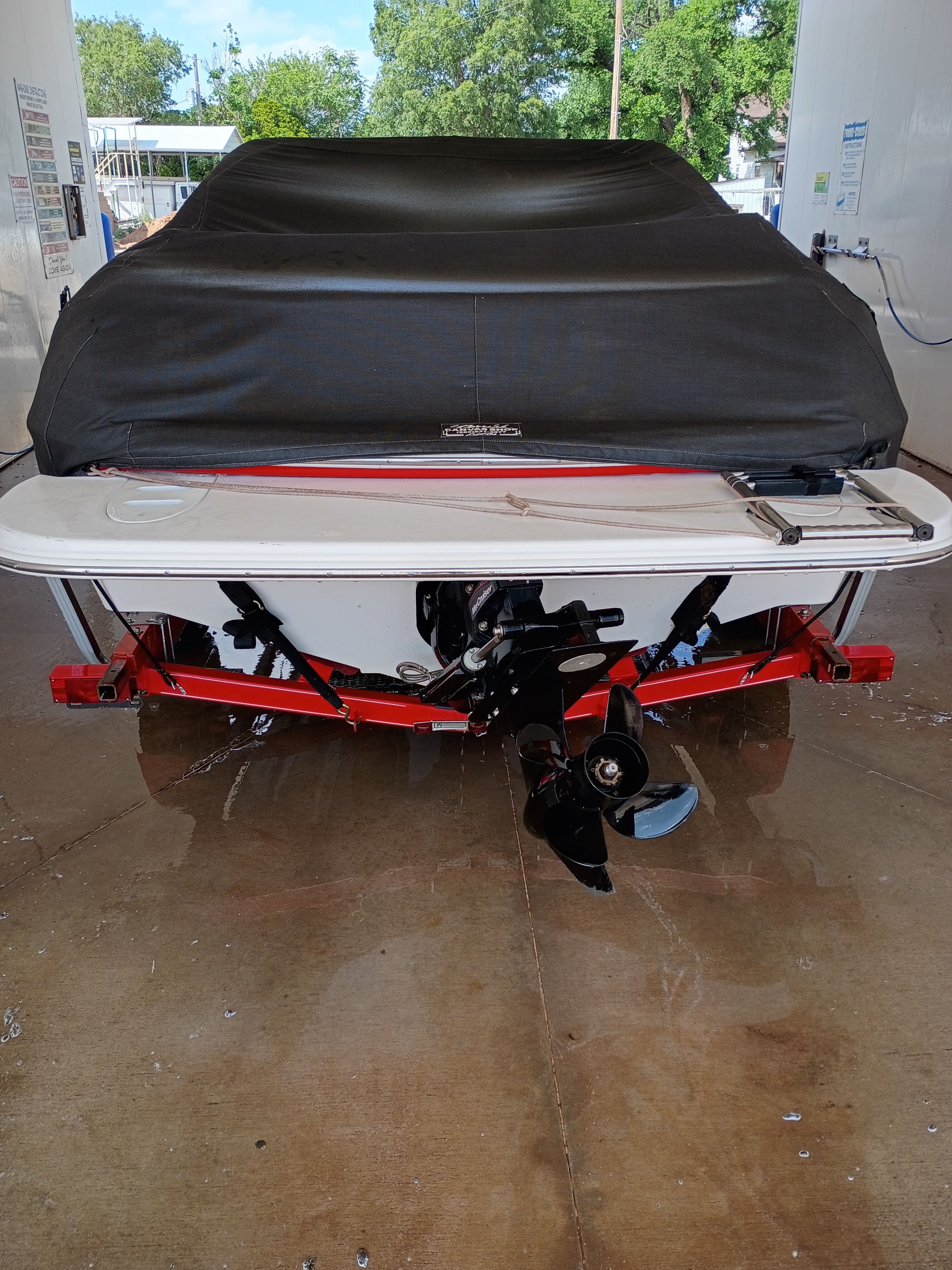 Rear view of a 2010 Glastron MX 185 boat with cover.