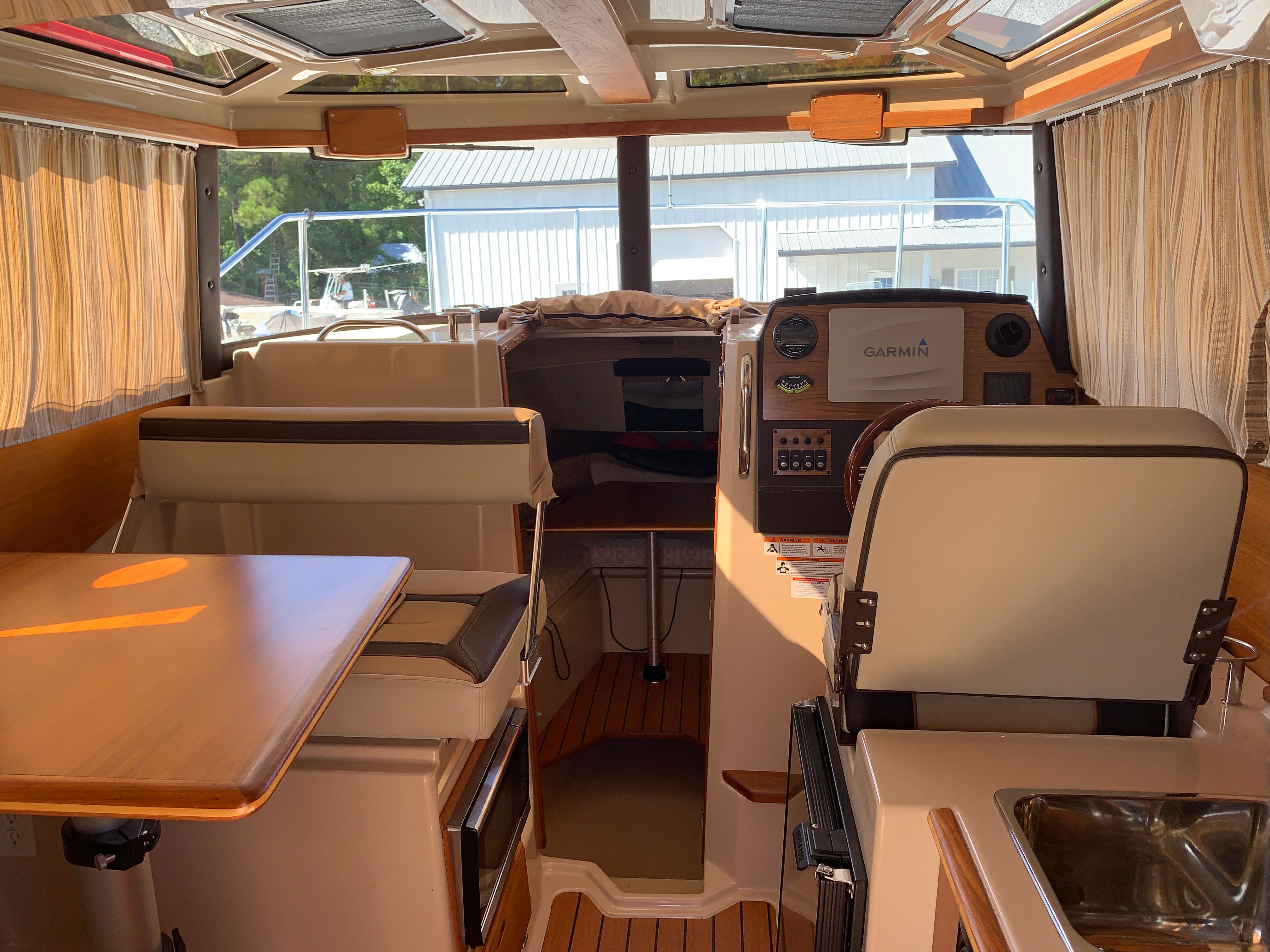 Interior of 2018 Ranger Tugs R-23 with helm and seating area.