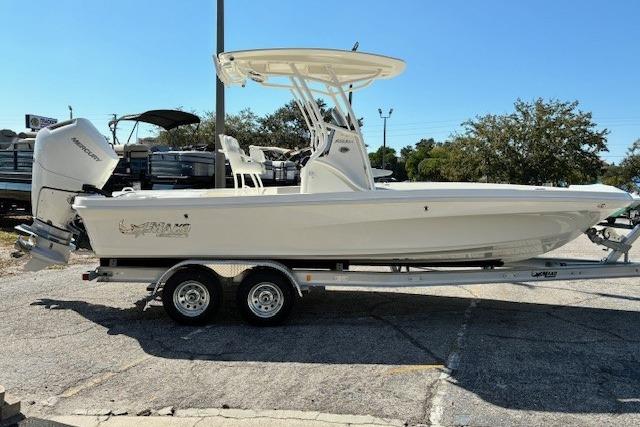 2026 Mako 24 APEX boat on trailer, side view, outdoors.
