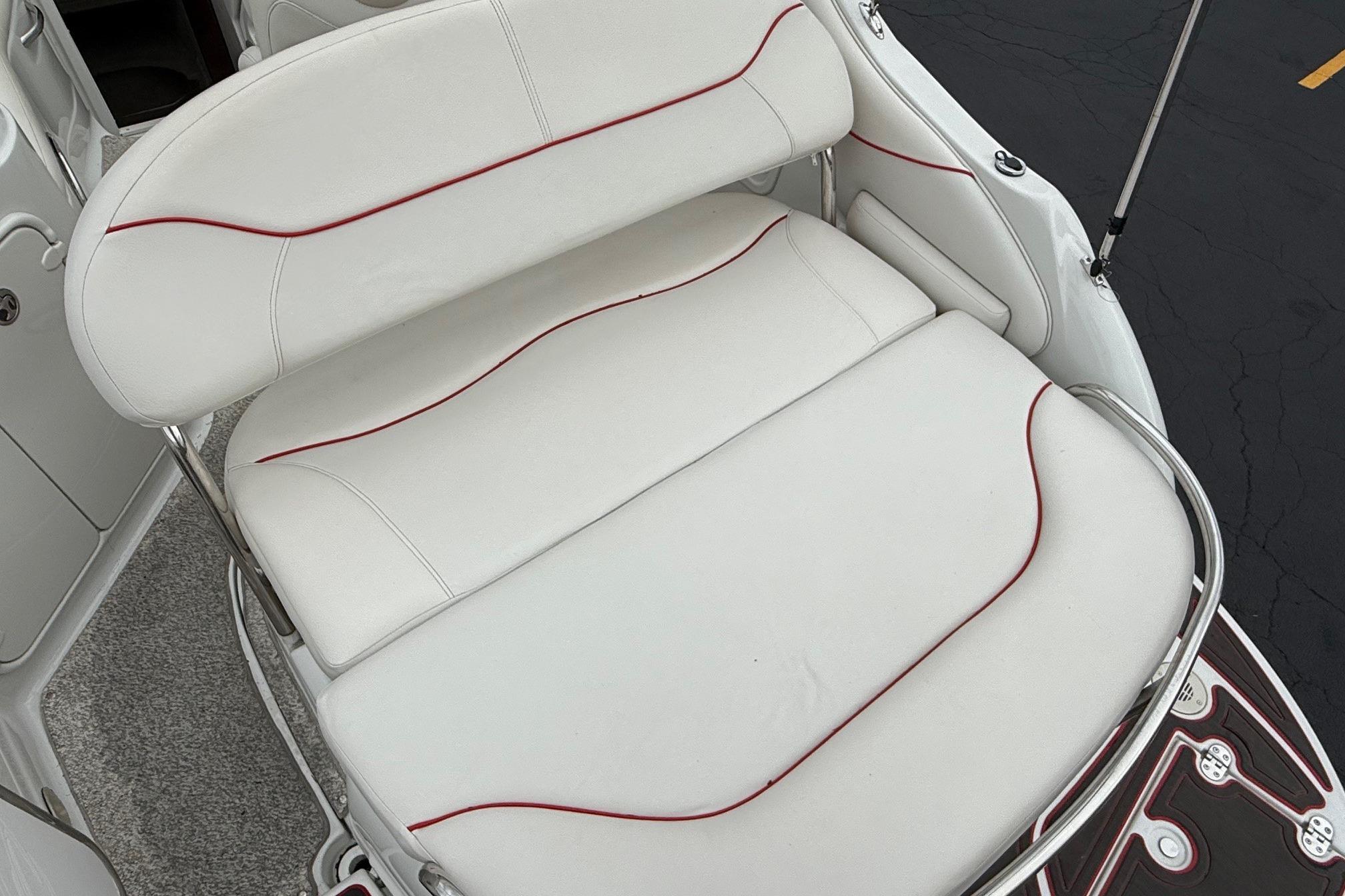 White leather boat seating with red accents on a 2005 Crownline 250 CR.