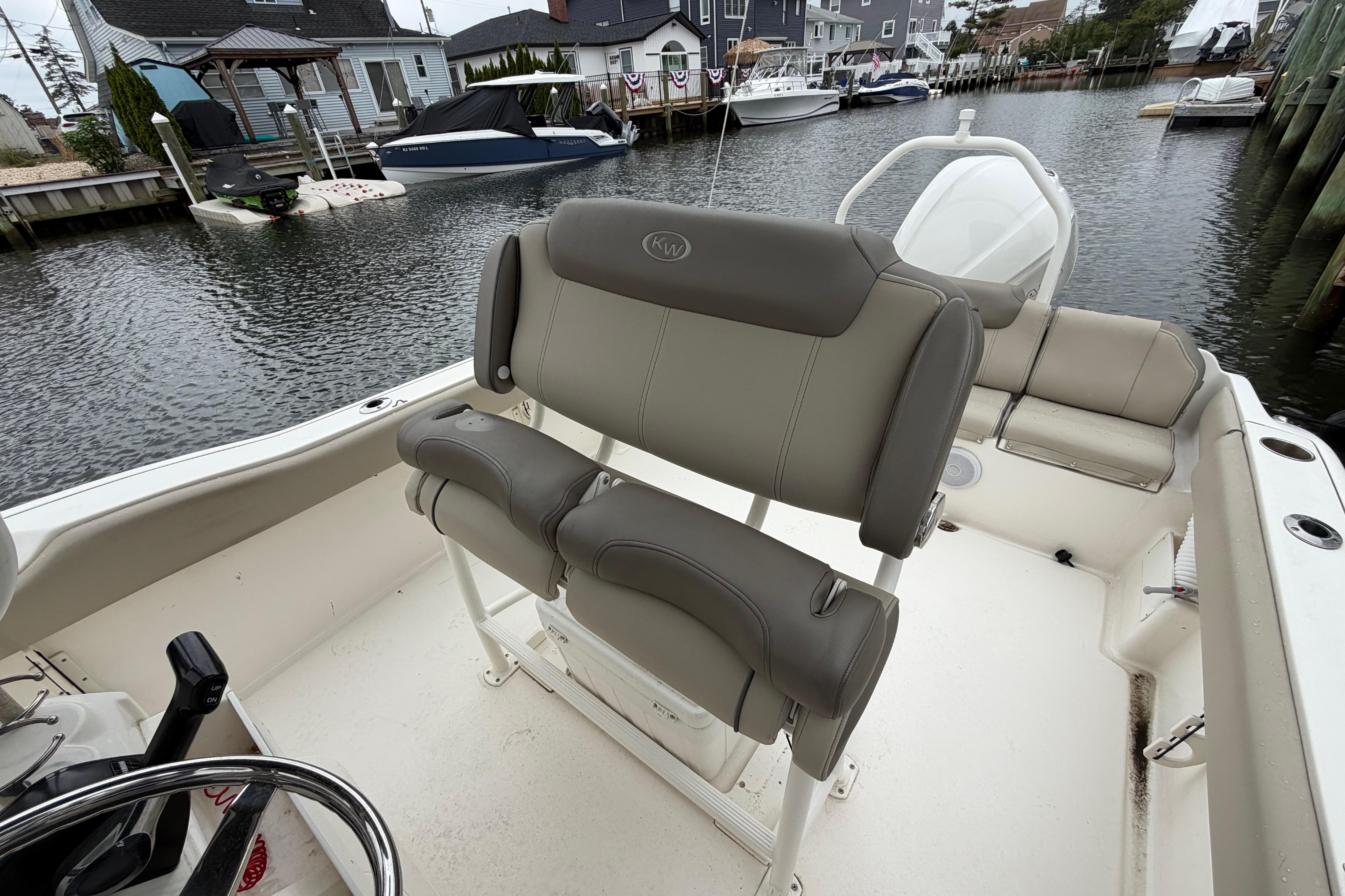 2022 Key West 239 FS boat interior with seating, docked in a marina.