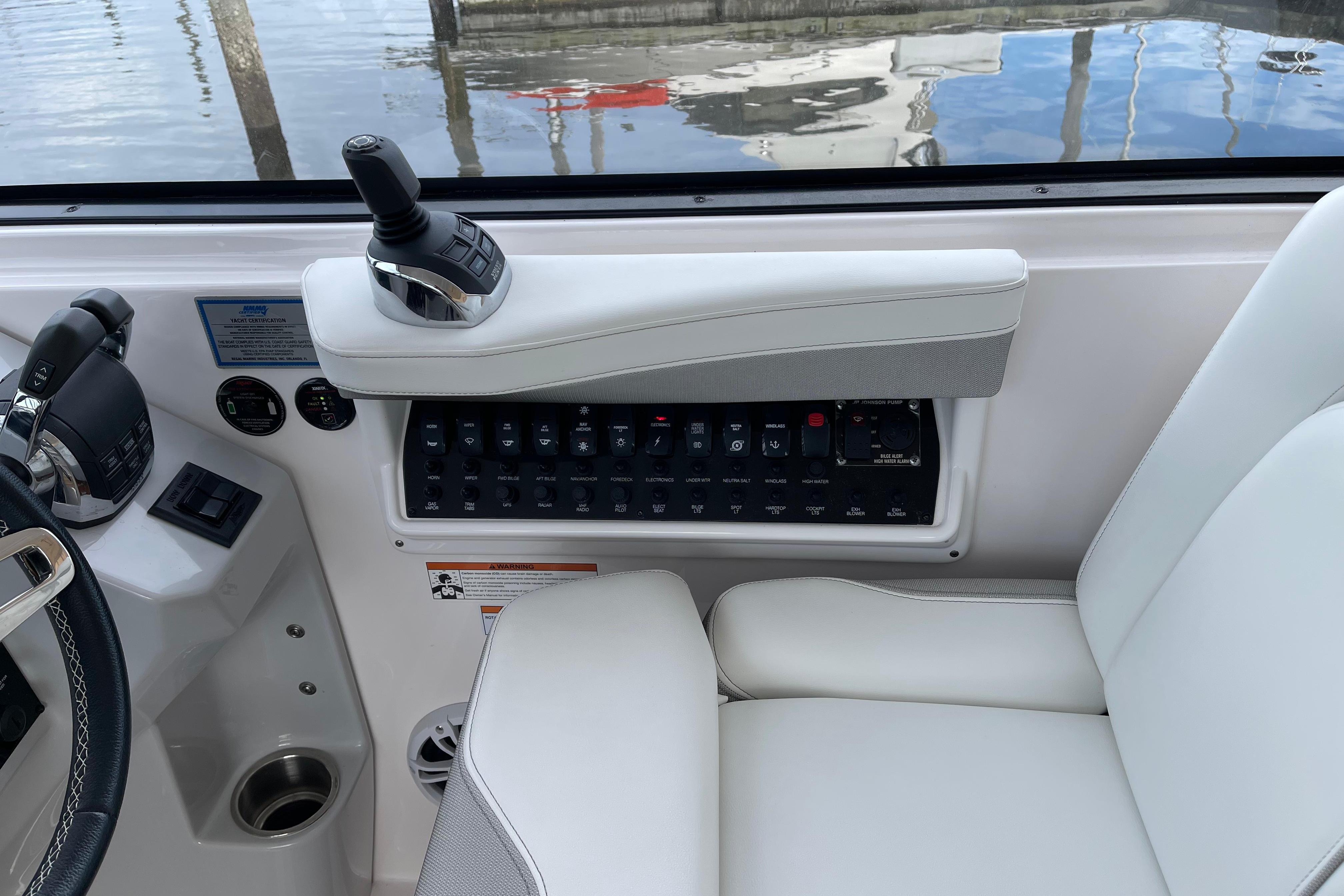 Control panel of a 2012 Regal 35 Sport Coupe boat with joystick and switches.