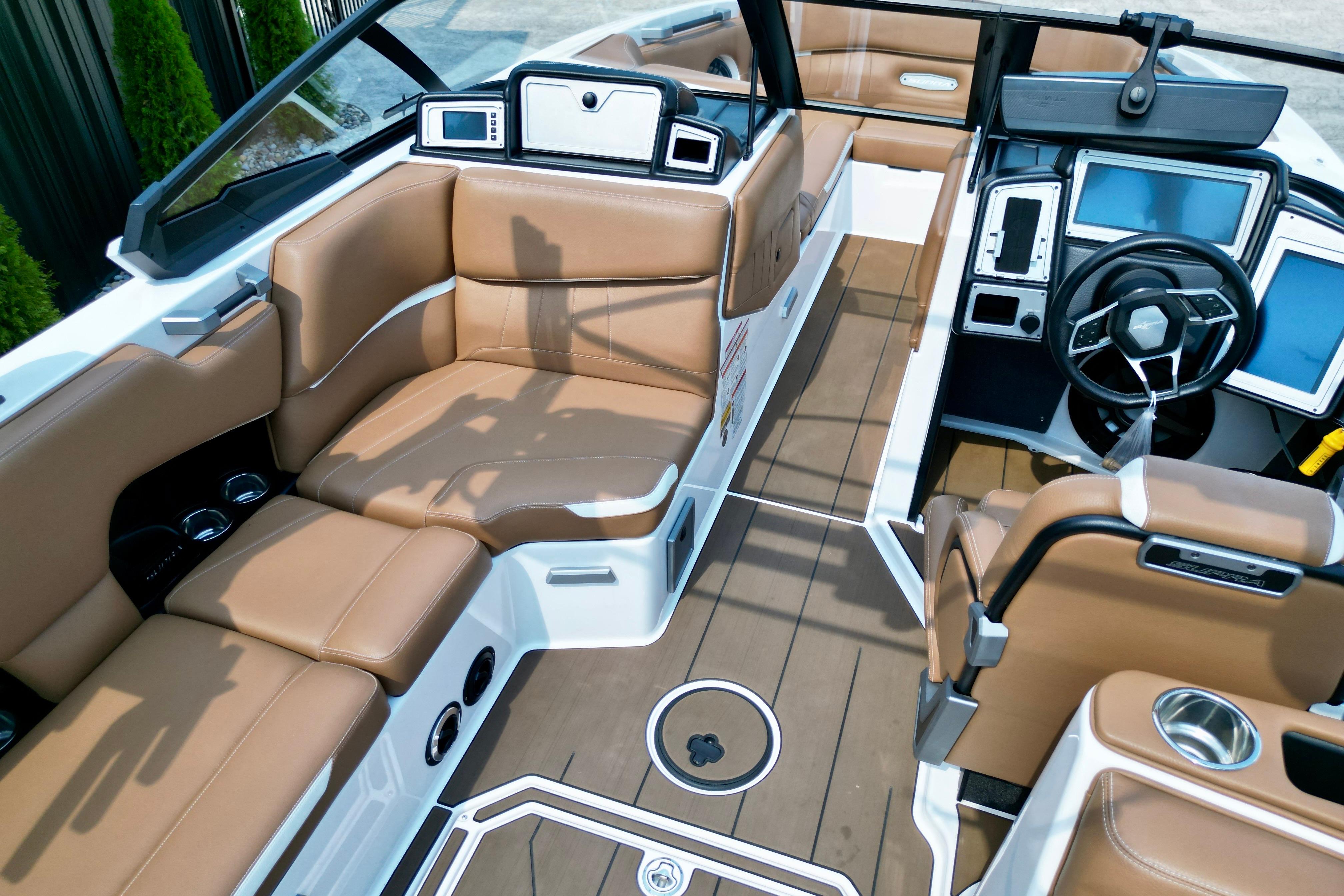 2021 Supra SE boat interior with luxurious tan seating and modern dashboard.