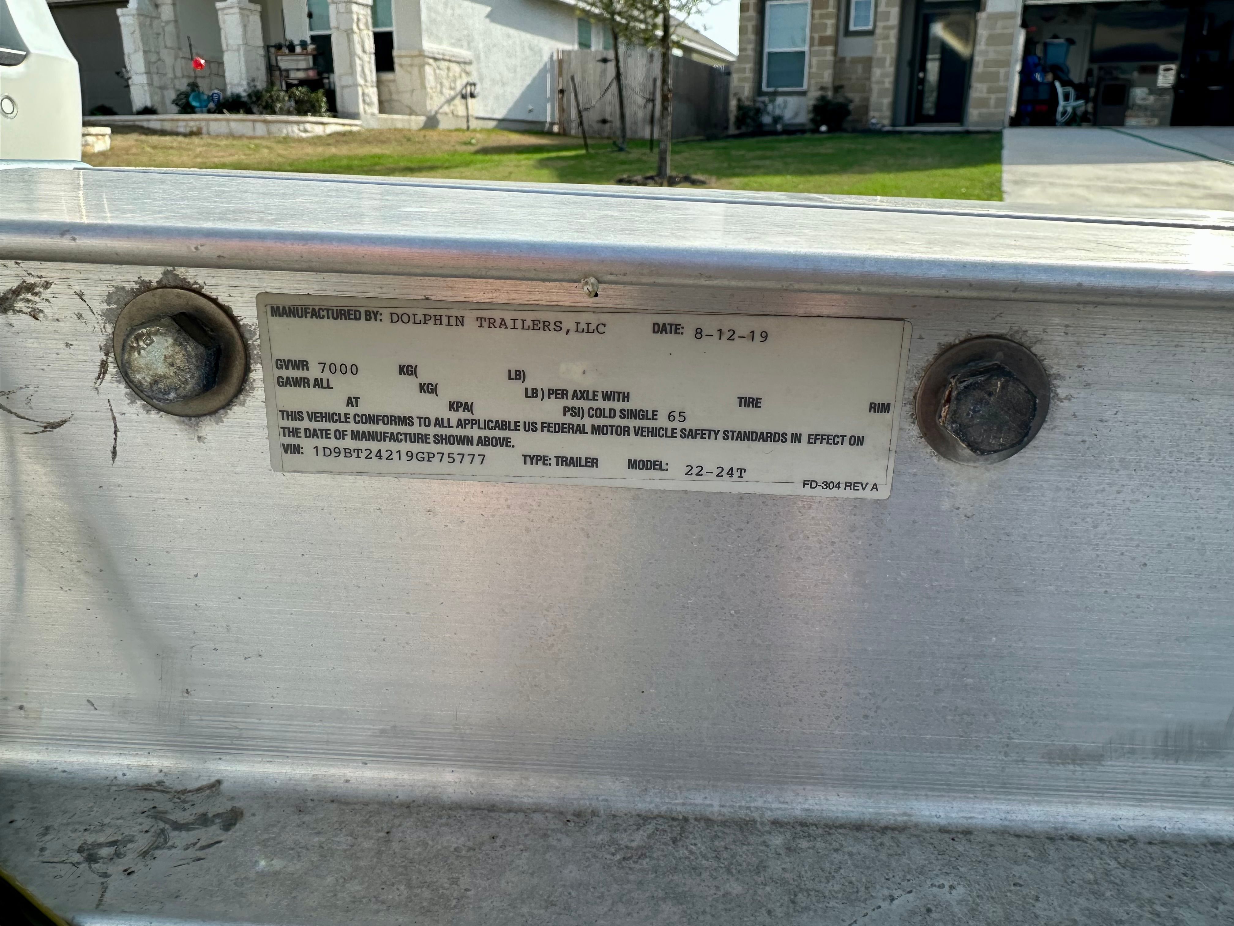Dolphin Trailers, LLC label with specifications on a trailer.