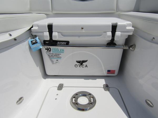 2024 Wellcraft 352 Fisherman boat with ORCA cooler in storage compartment.