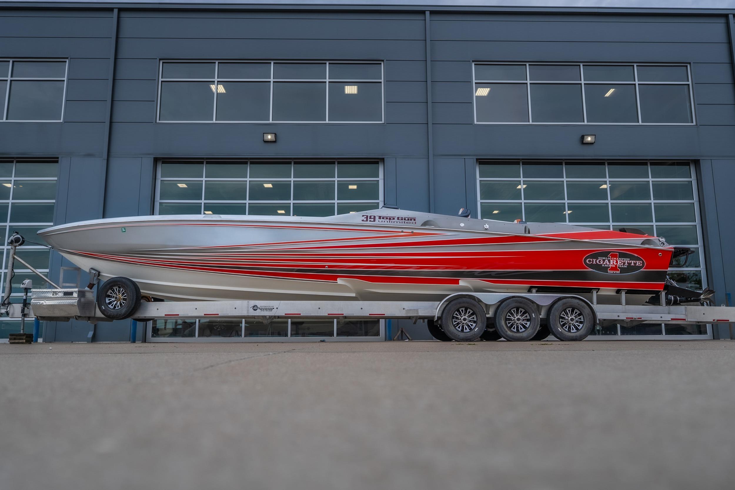 2006 Cigarette 39' Top Gun Unlimited boat on trailer, sleek design with red and silver accents.