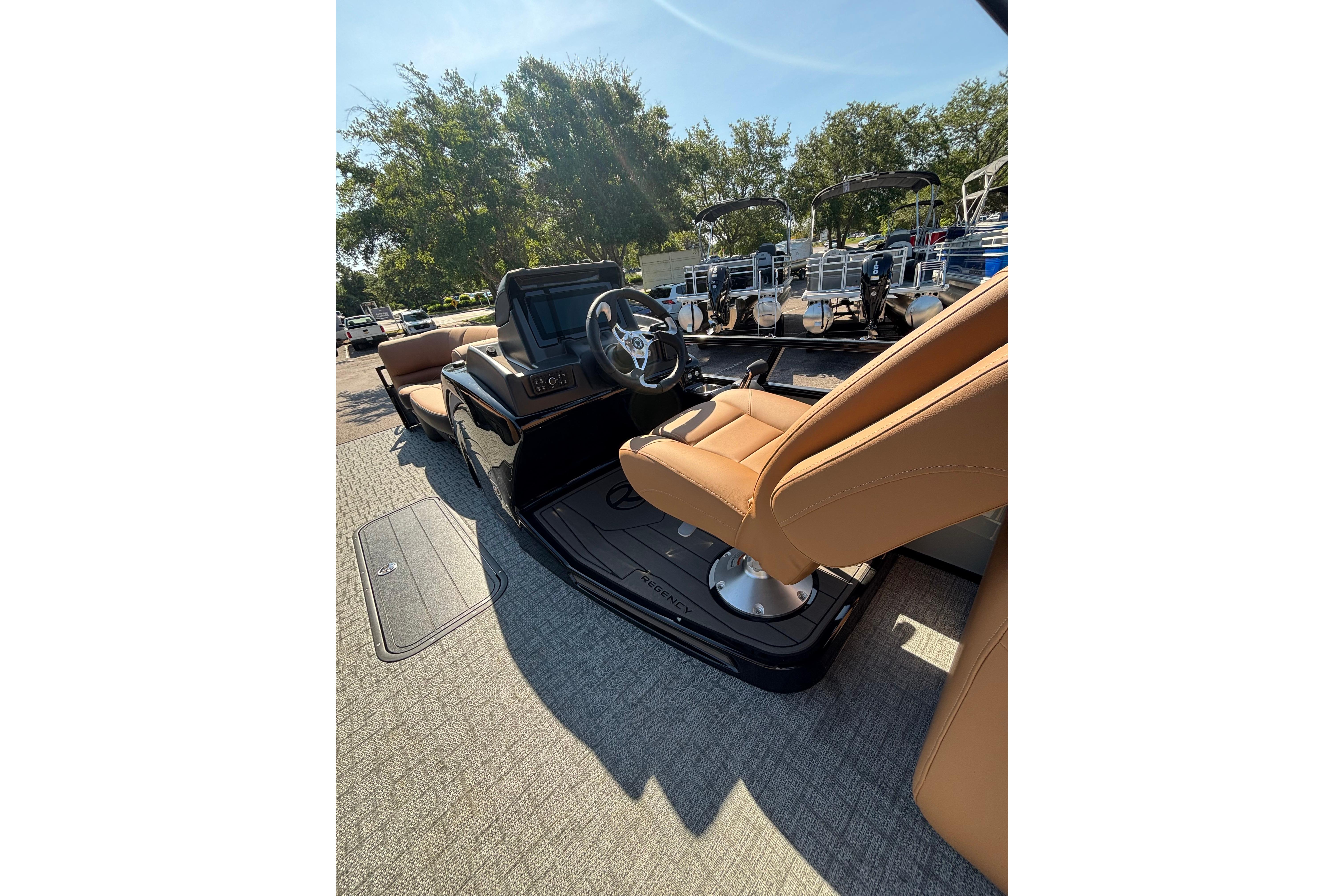 2026 Regency 230 DL boat interior with tan seating and modern steering console.