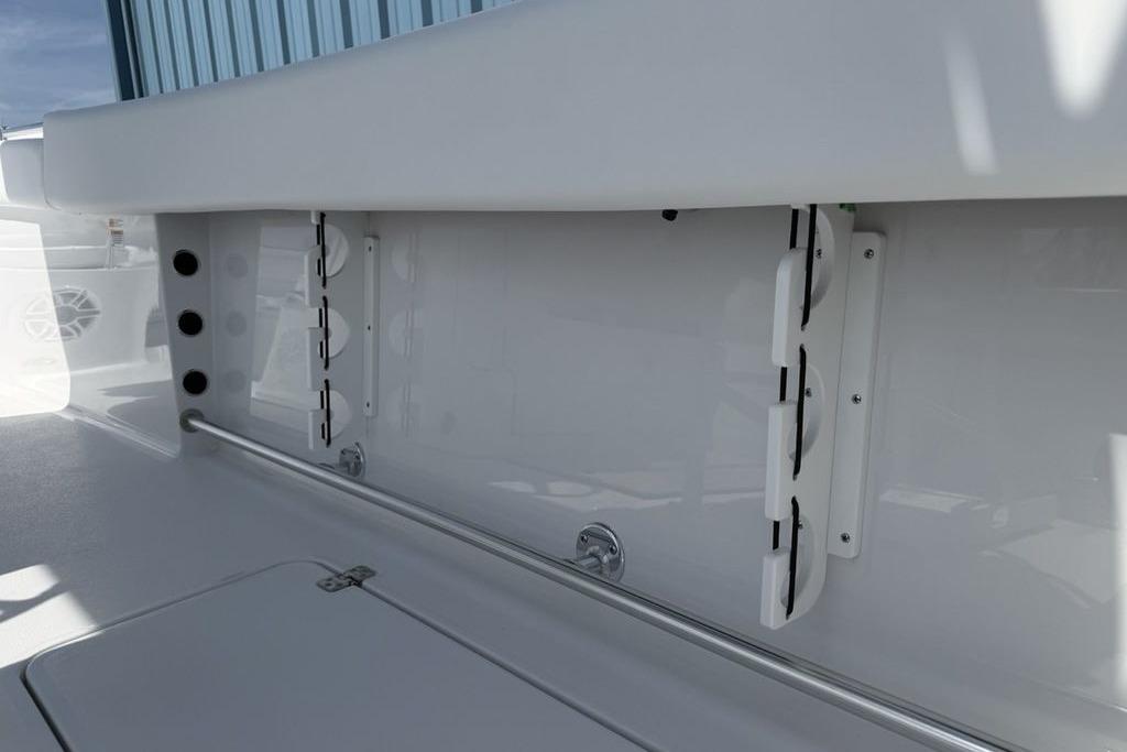 2026 Sportsman Open 252 Center Console boat interior, featuring rod holders and storage compartments.