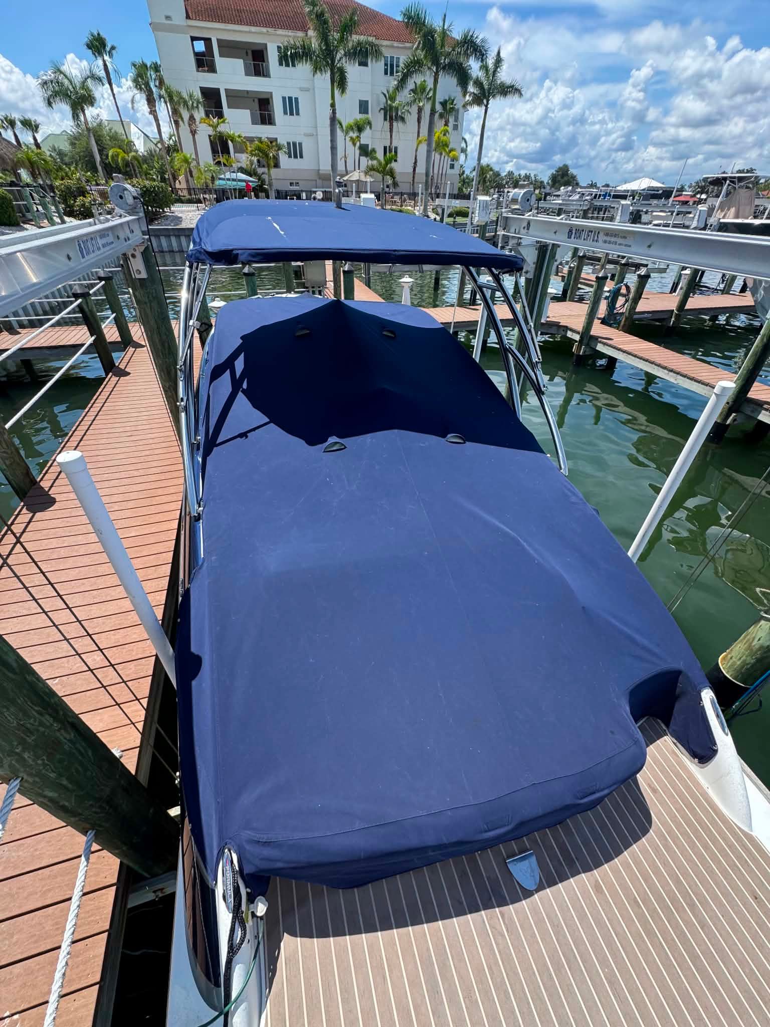 2018 Formula 270 Bowrider with blue cover at dock.