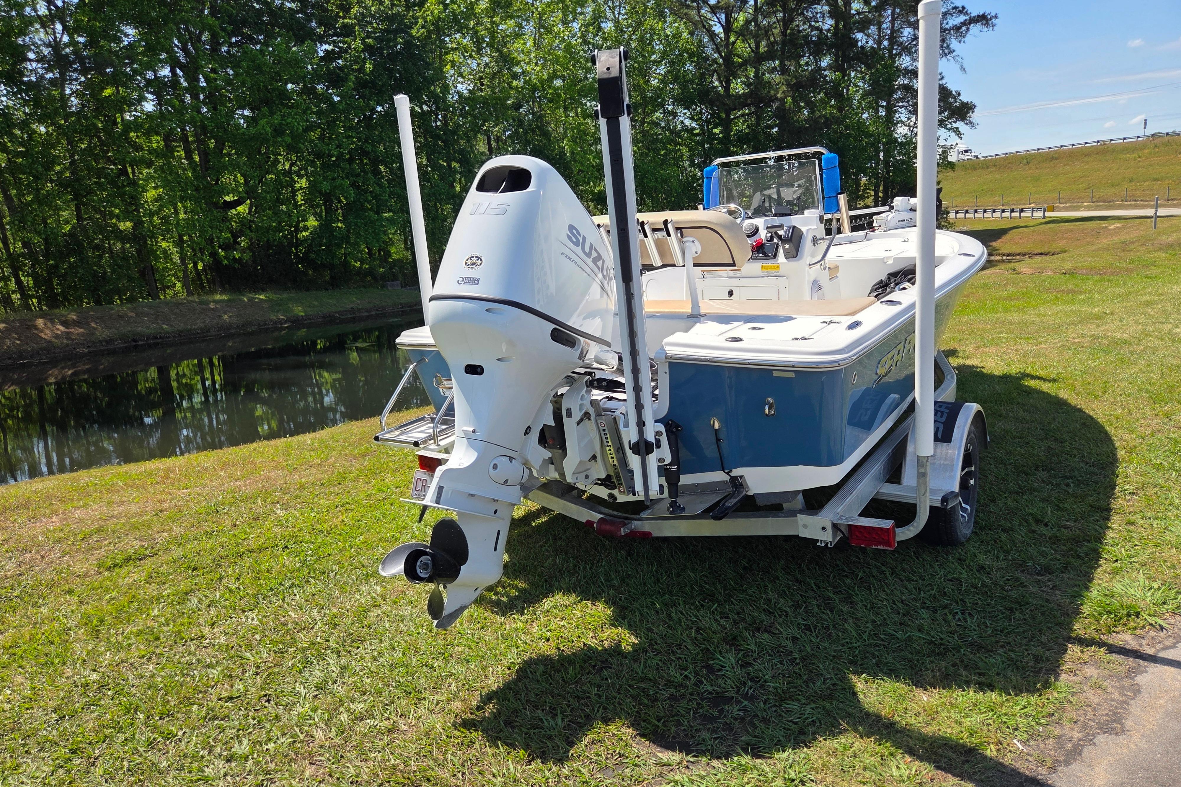2024 Sea Pro 172 Bay boat on trailer near a scenic waterway.