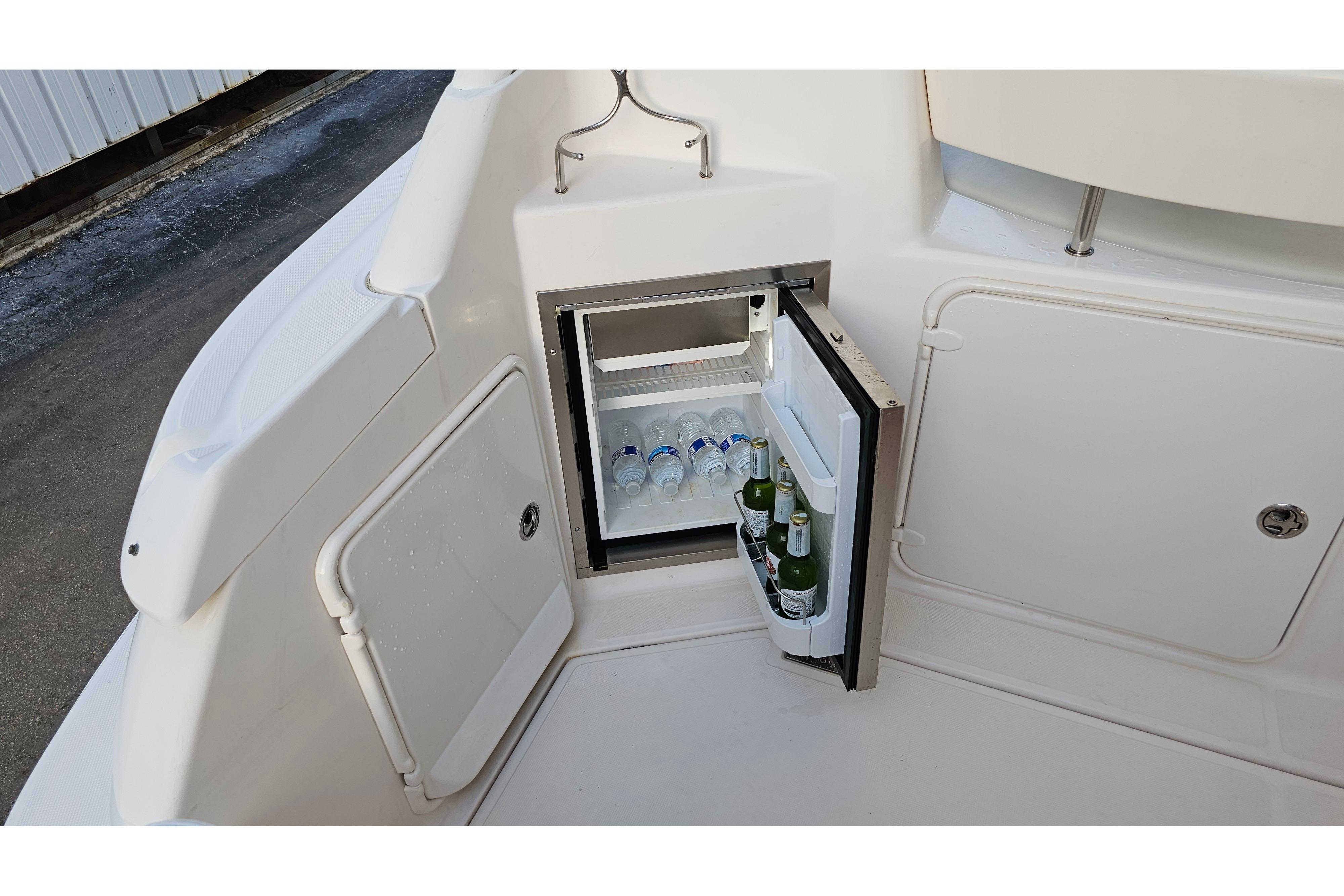 Mini fridge on 2005 Regal 3060 Window Express boat, stocked with drinks.