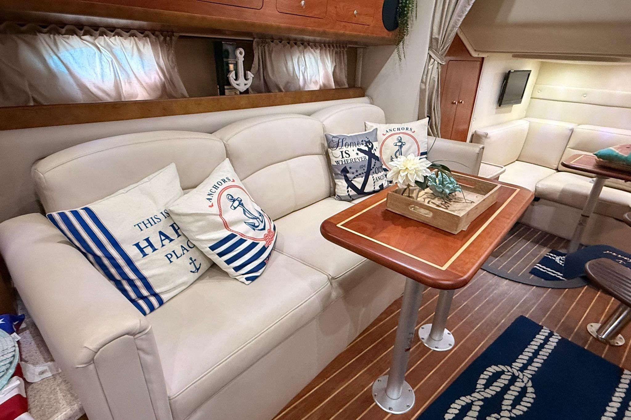 Interior of 2007 Rinker 350 Express Cruiser with nautical-themed decor and cozy seating.