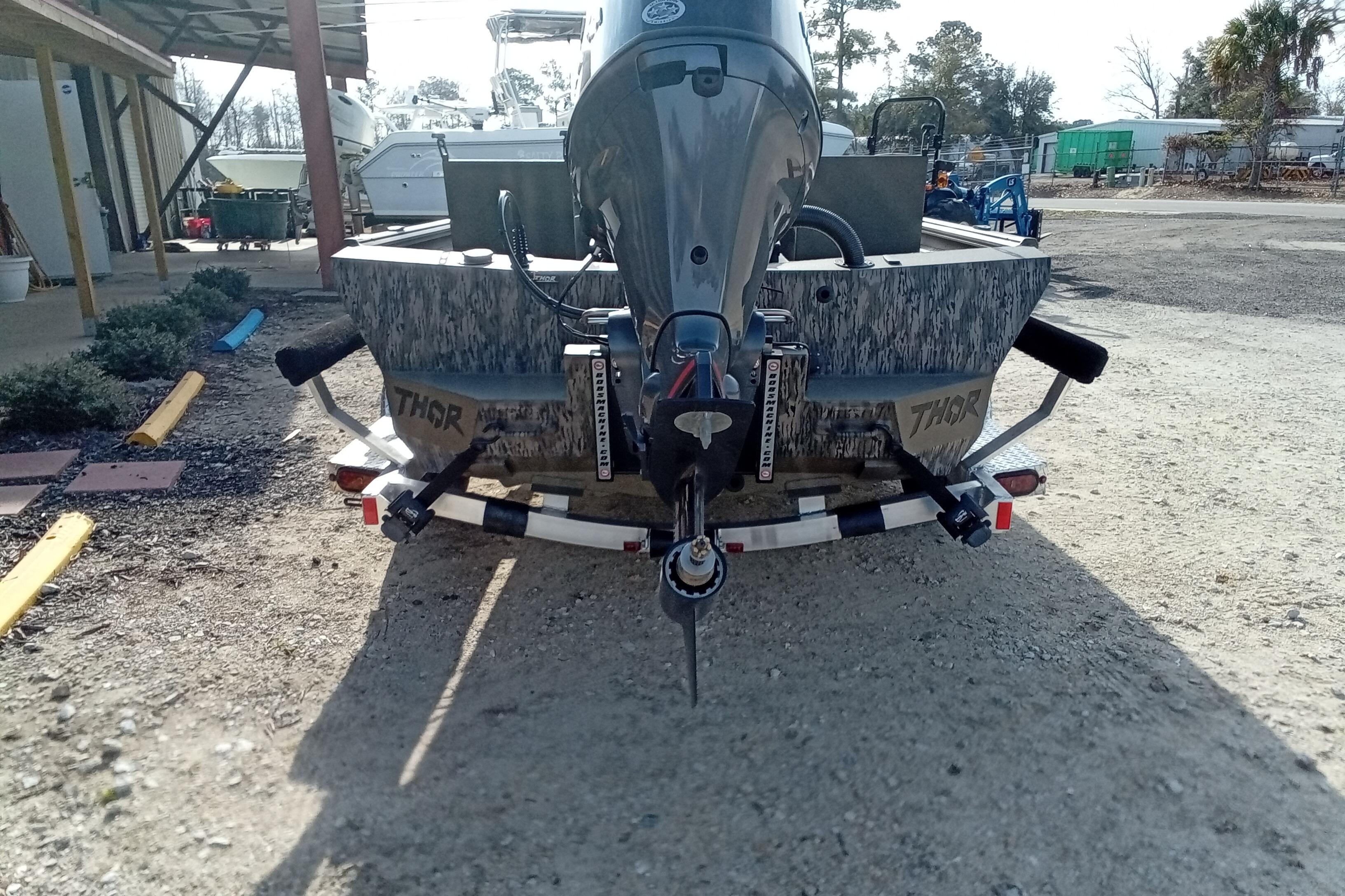 2026 Thor 1900 Low Country Elite boat on trailer, rear view, outdoors.