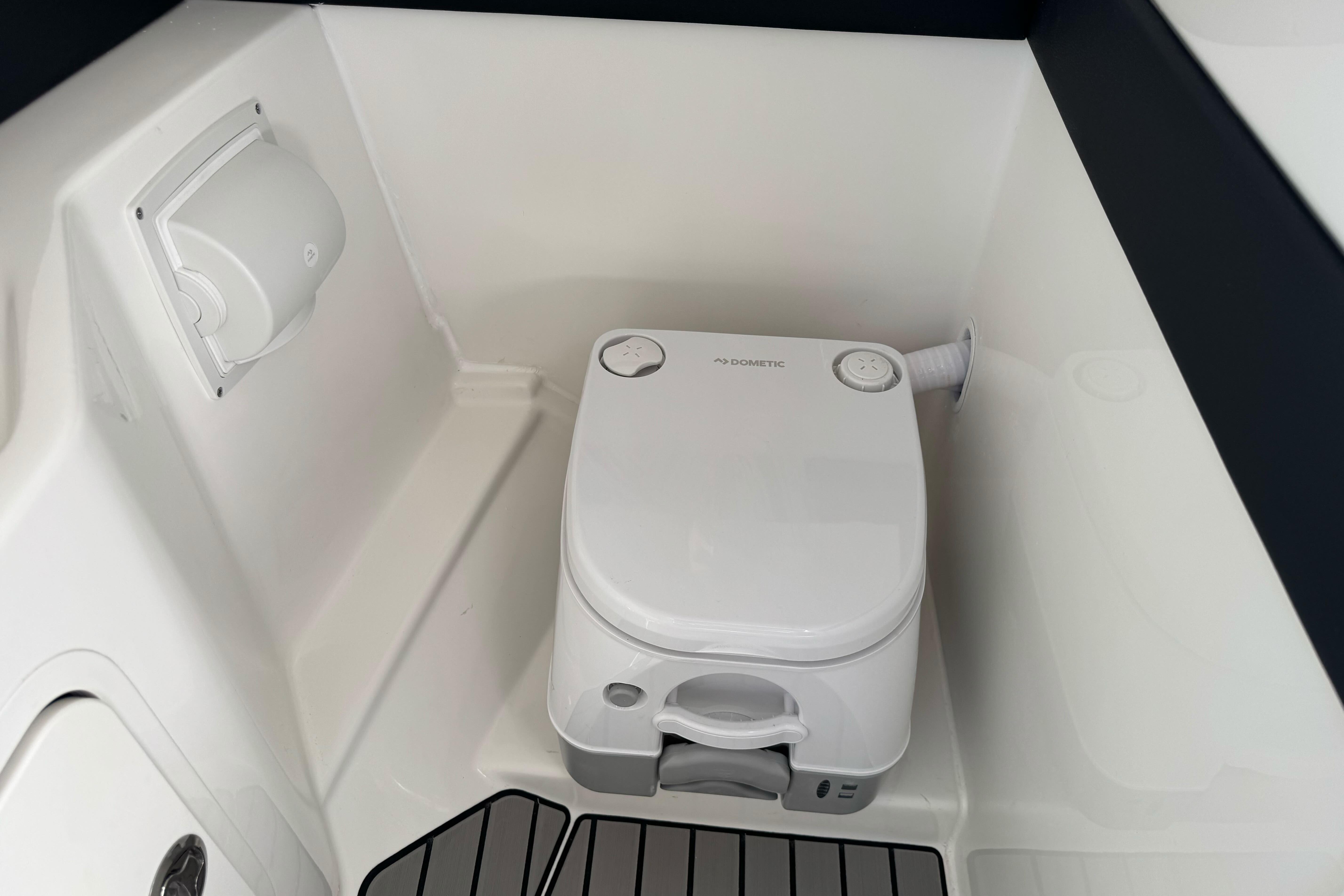 Portable toilet in 2026 Sea Ray SLX 260 boat interior.
