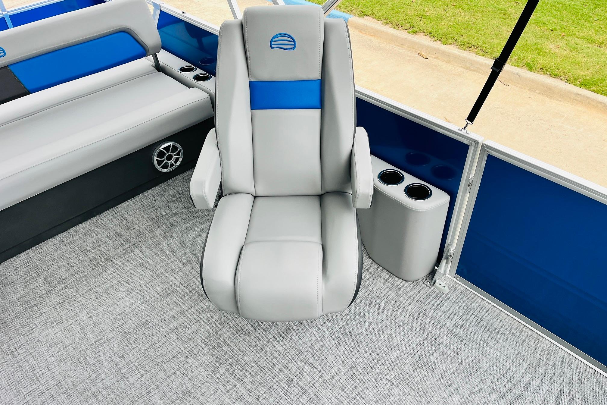 2026 Sun Tracker Party Barge 22 RF DLX interior with gray seating and cup holders.