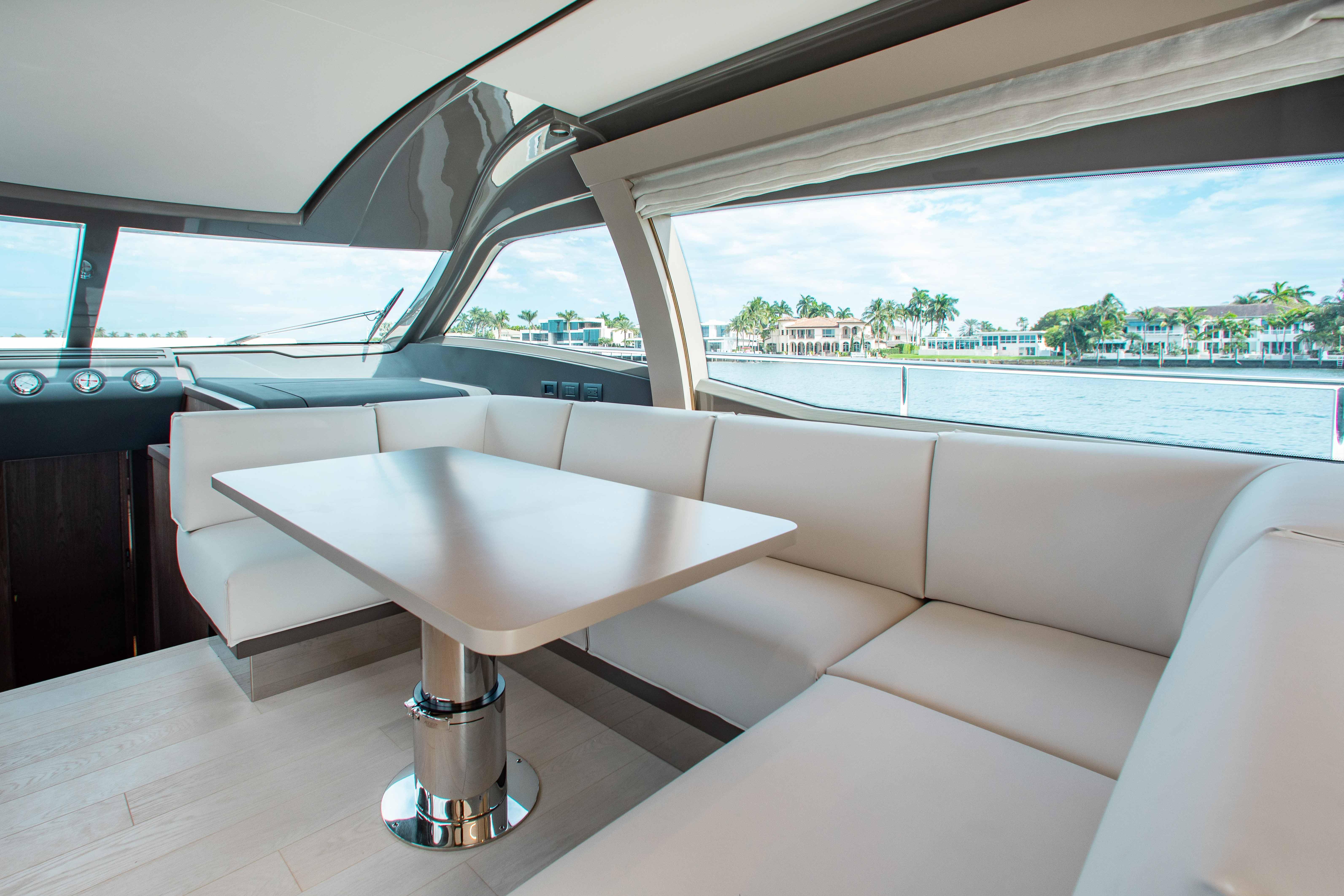 Luxurious interior of 2022 Ferretti Yachts 550 with elegant seating and scenic water view.
