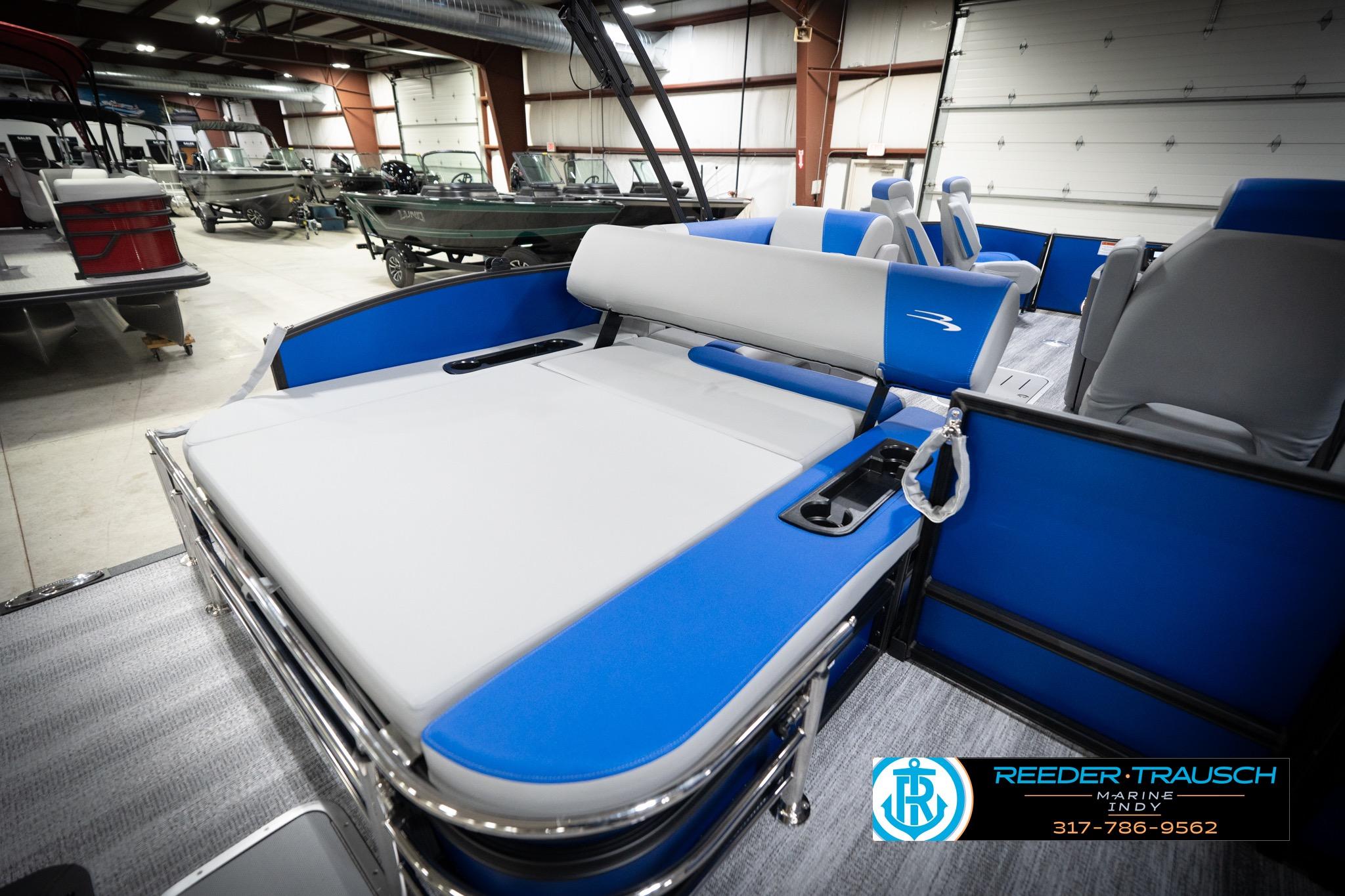 2026 Bennington 22 SSB pontoon boat interior with blue and gray seating in showroom.