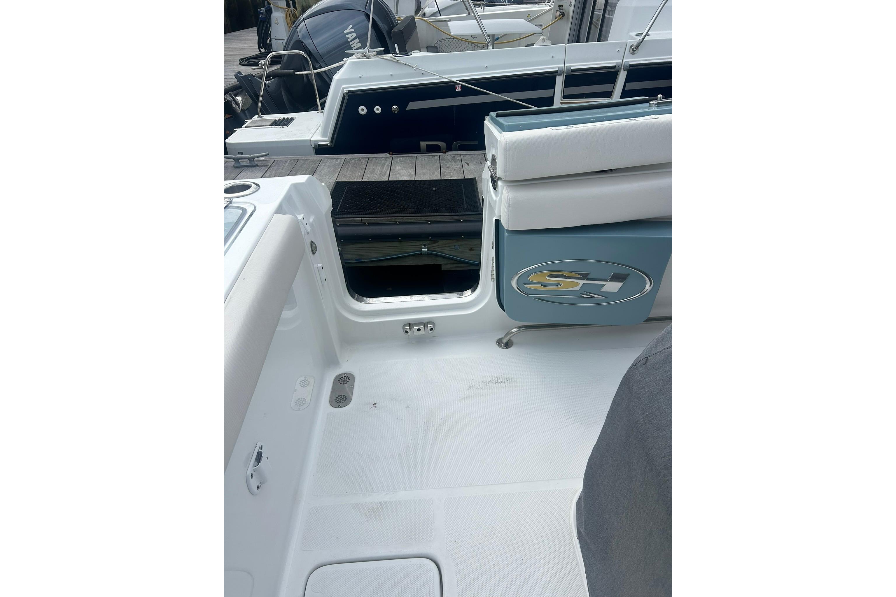2021 Sea Hunt Gamefish 27 Coffin Box boat interior with open storage compartment.