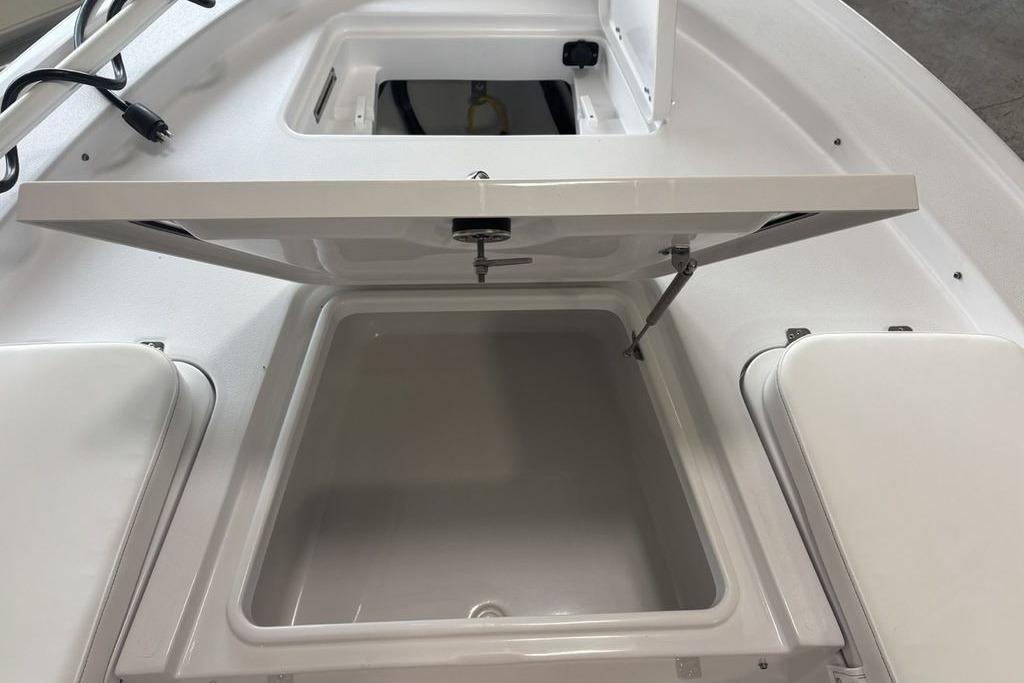 2026 Sportsman Masters 247 Bay Boat storage compartment with open hatch, showcasing interior space.