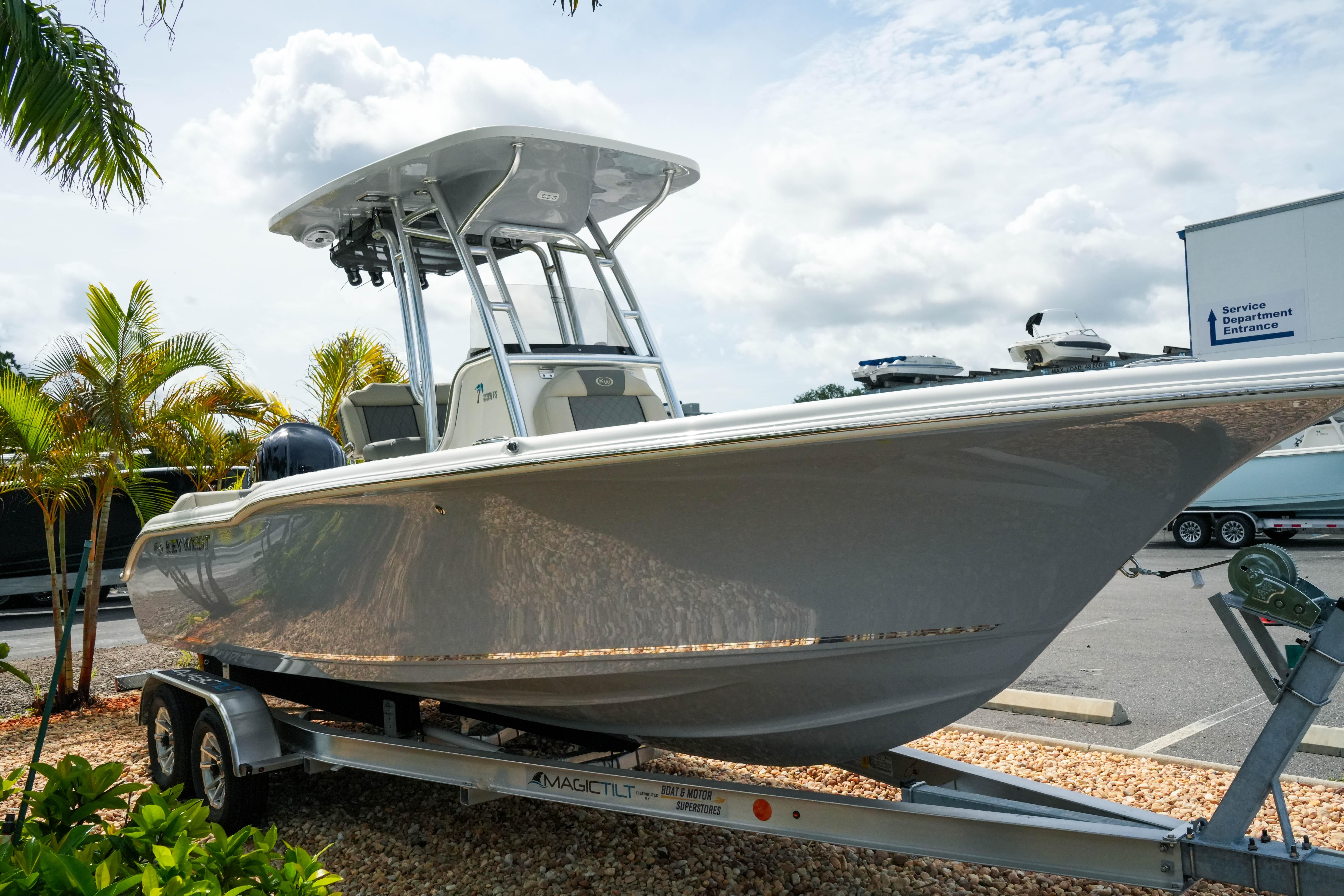 2026 Key West 239 FS boat on trailer, parked outdoors near palm trees.
