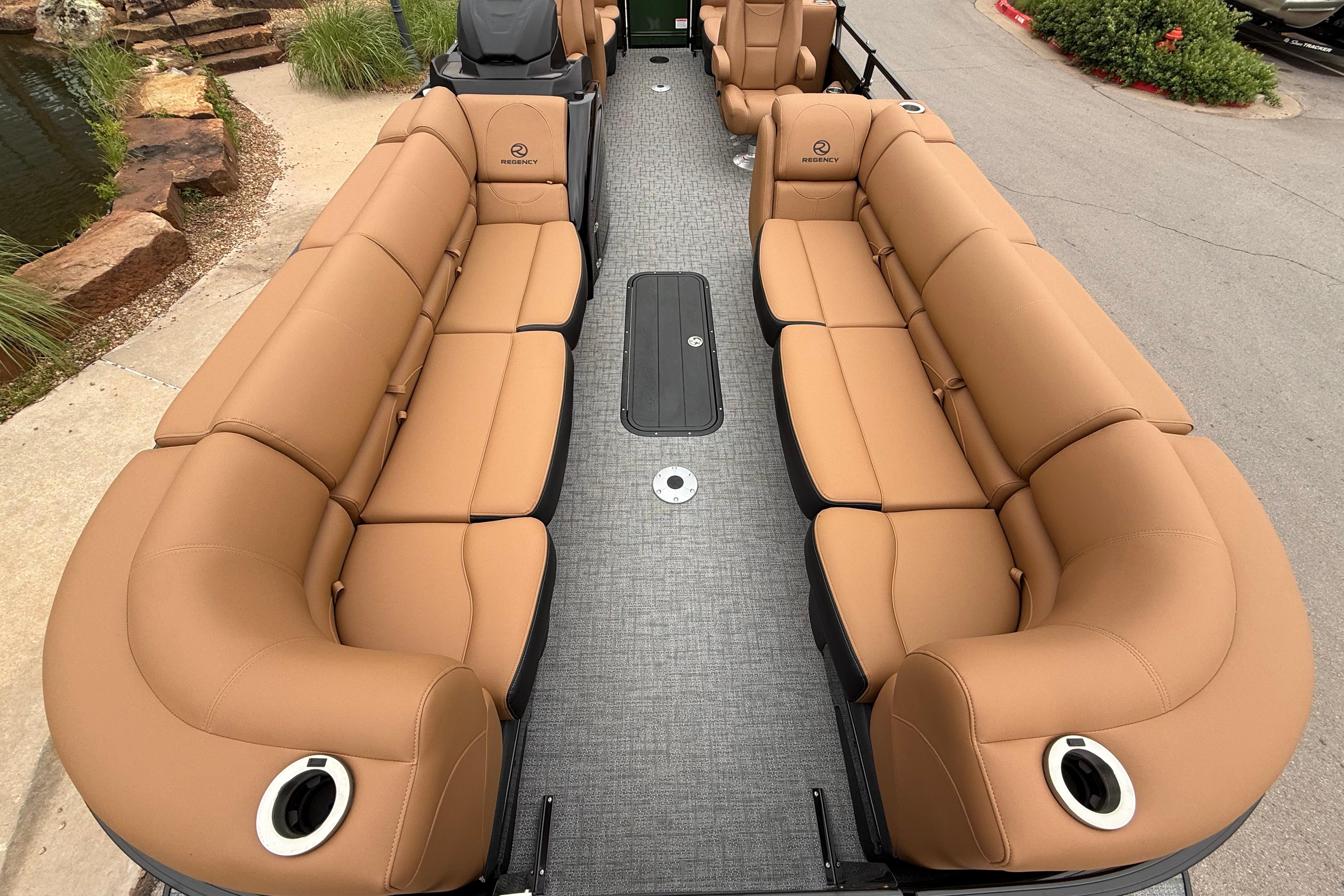 Luxurious seating on 2026 Regency 250 DL pontoon boat, featuring tan upholstery and spacious layout.
