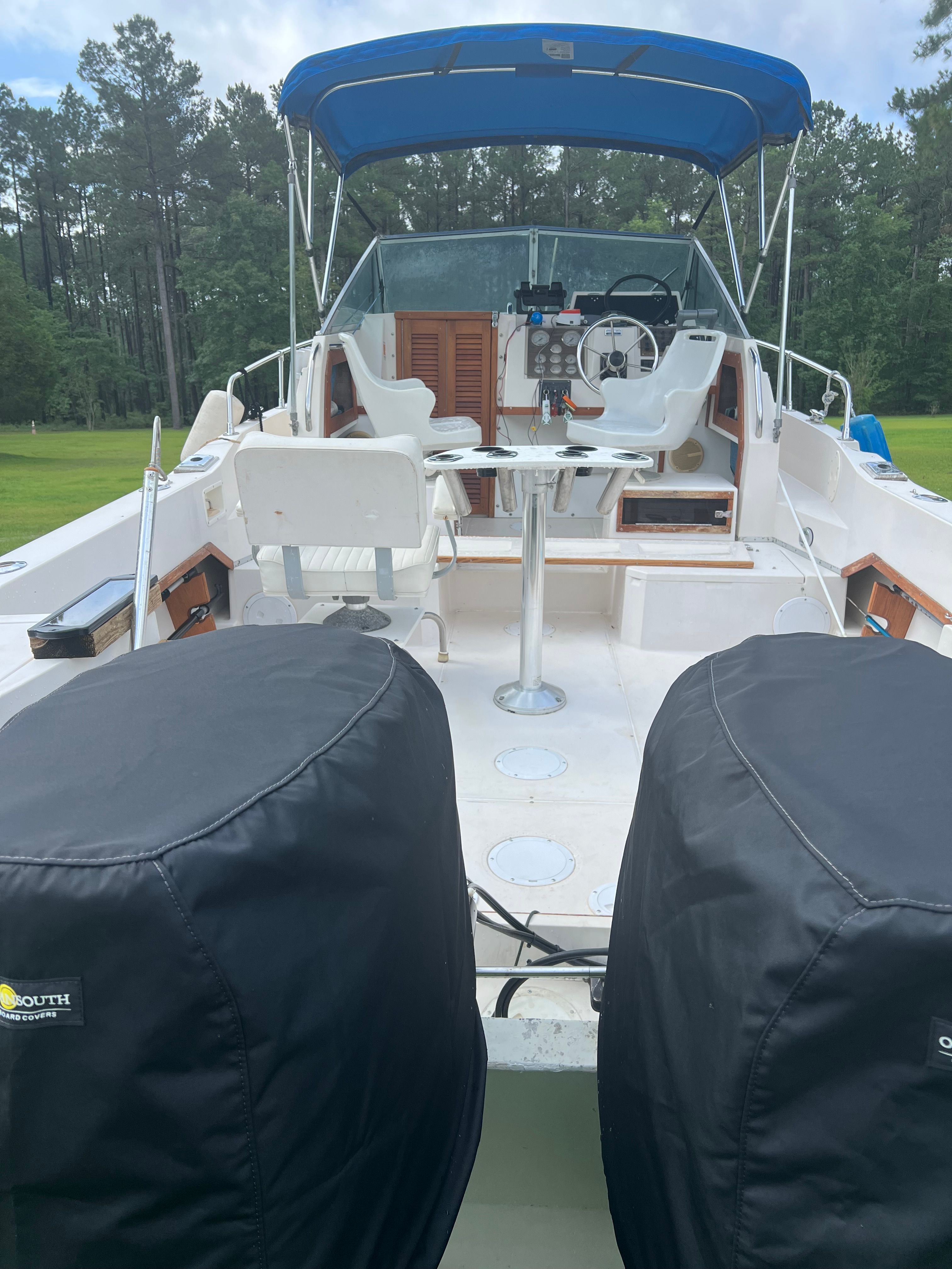 1987 Grady-White Gulfstream boat with blue canopy and seating area.