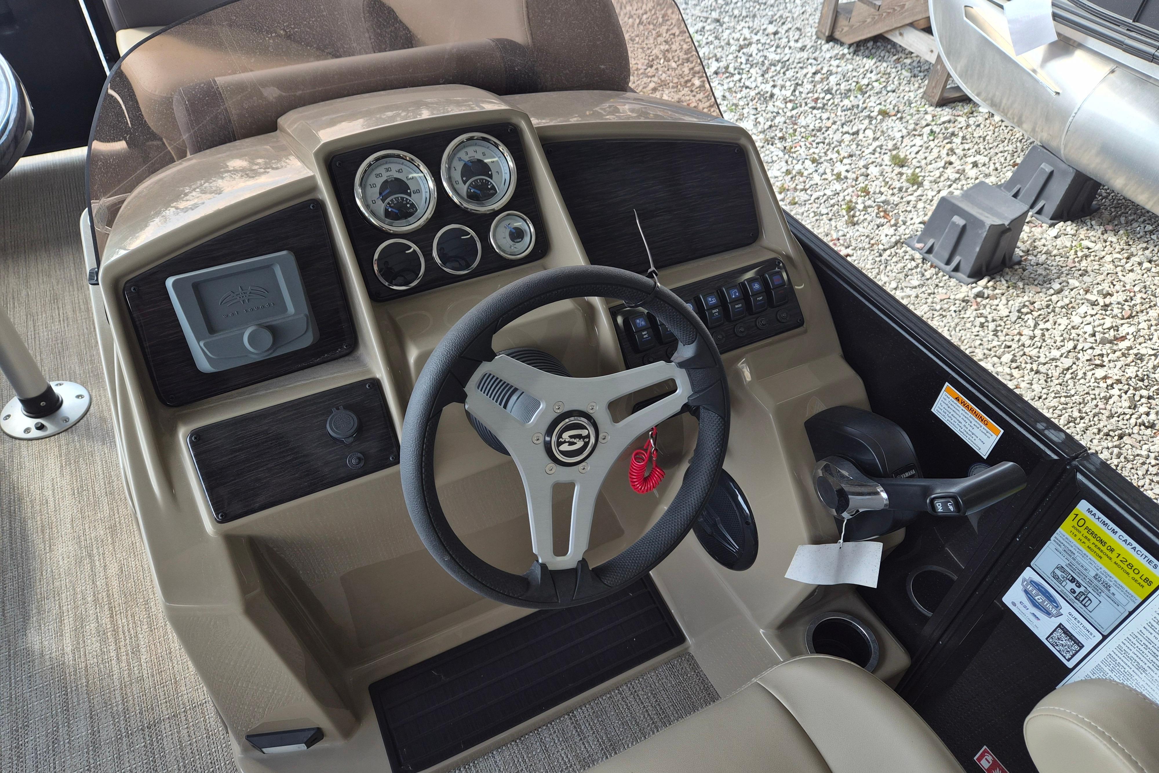 Steering console of 2026 Sylvan Mirage 820 CLZ DH pontoon boat, featuring gauges and controls.