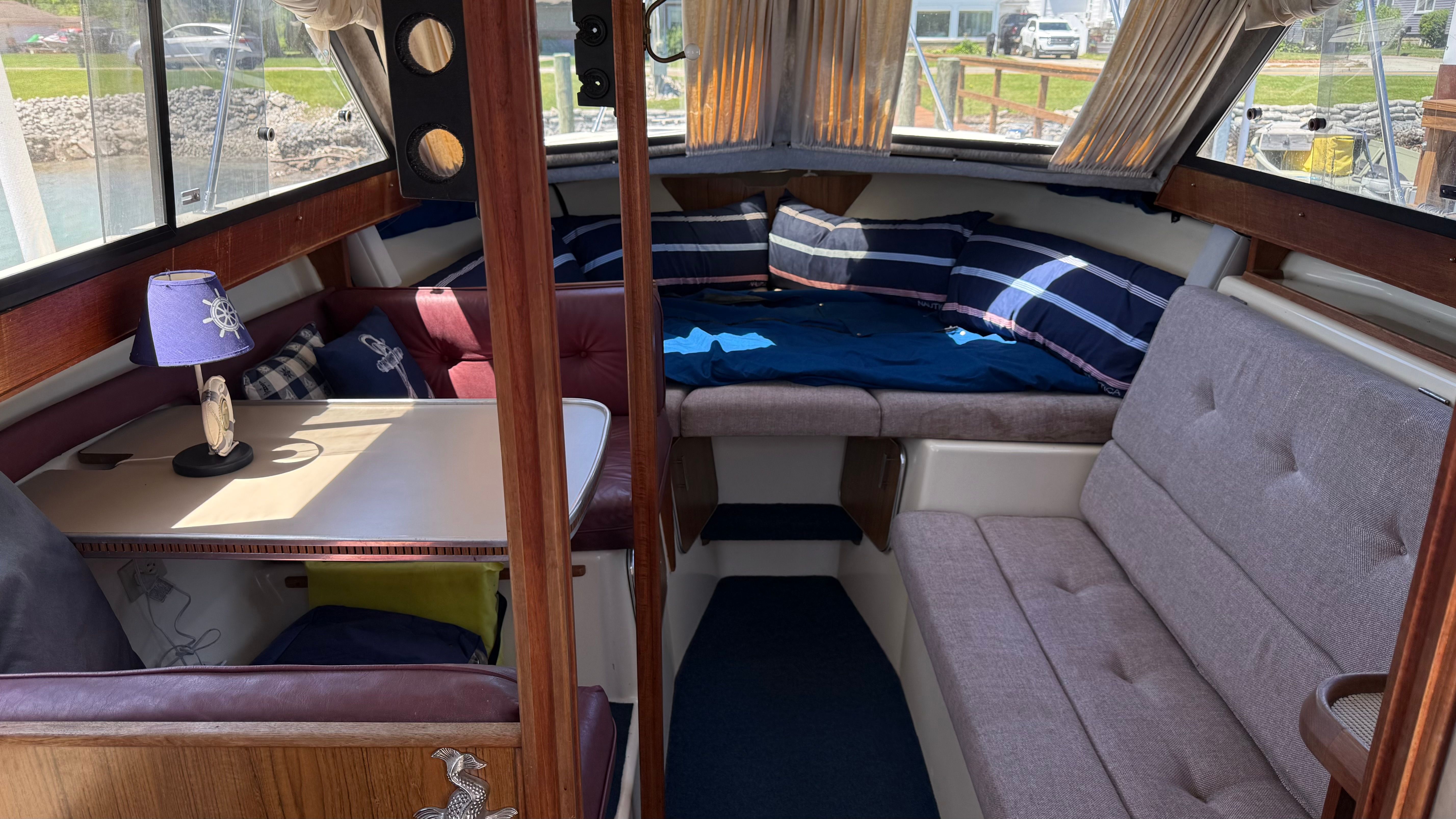 Interior of a 1986 Chris-Craft 292 Catalina Sunbridge with cozy seating and cushions.