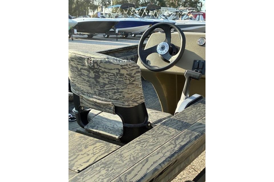 2026 Tracker Grizzly 1754 SC boat interior with camo seat and steering wheel.