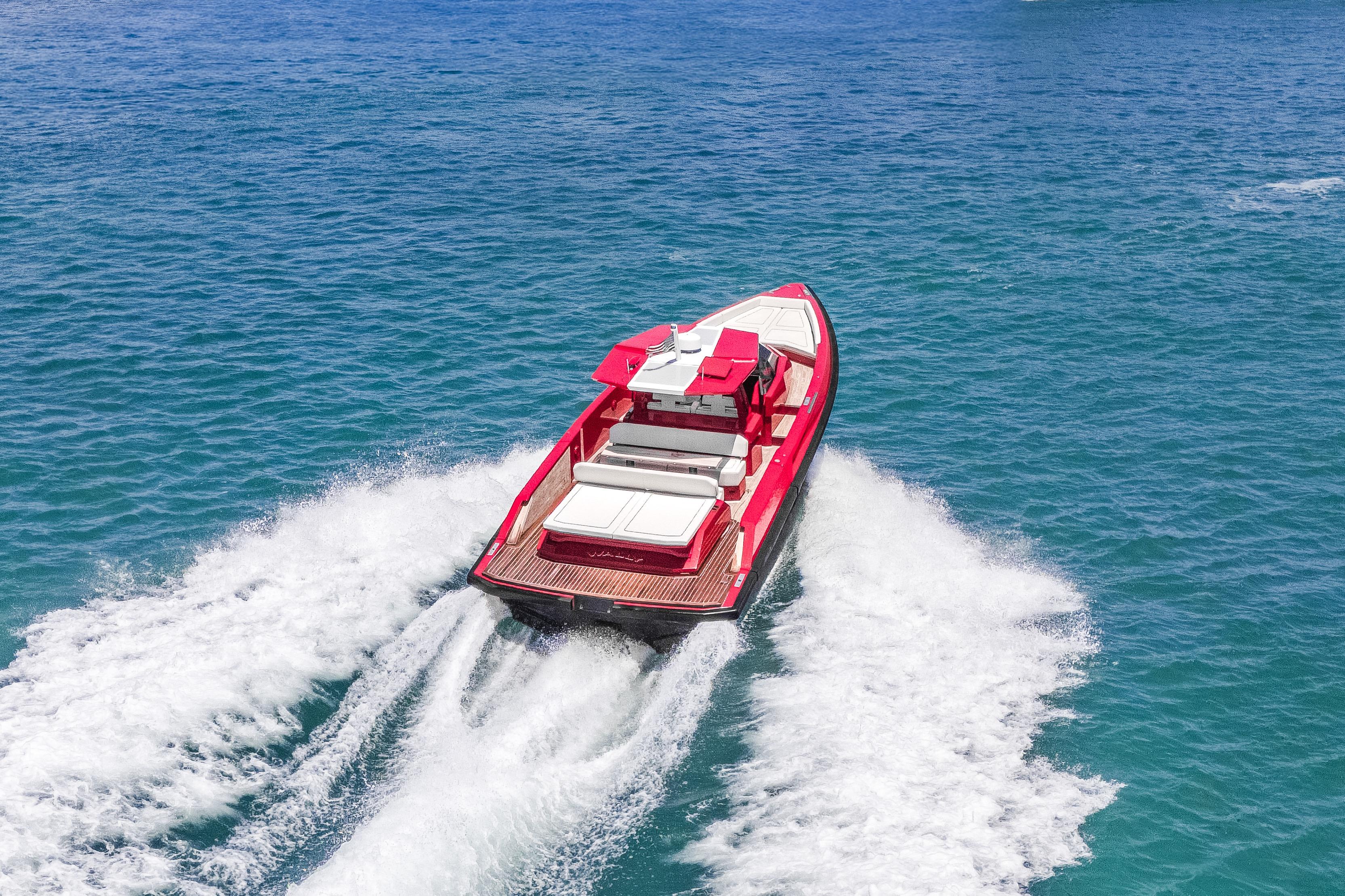 Red 2021 Wally 48 yacht cruising on clear blue ocean waters.