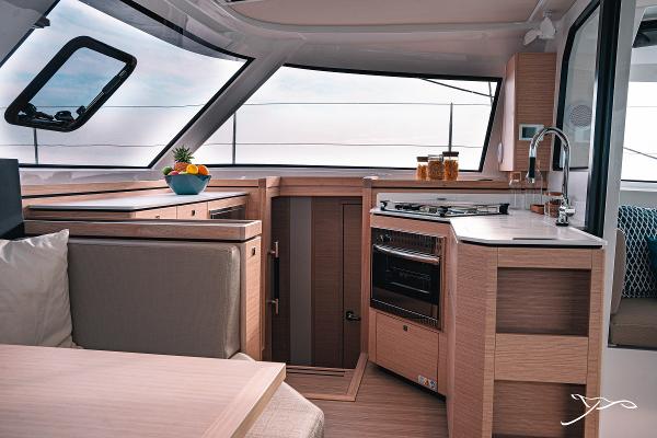 Modern kitchen interior of 2025 Nautitech 40 Open catamaran with sleek design and ample natural light.