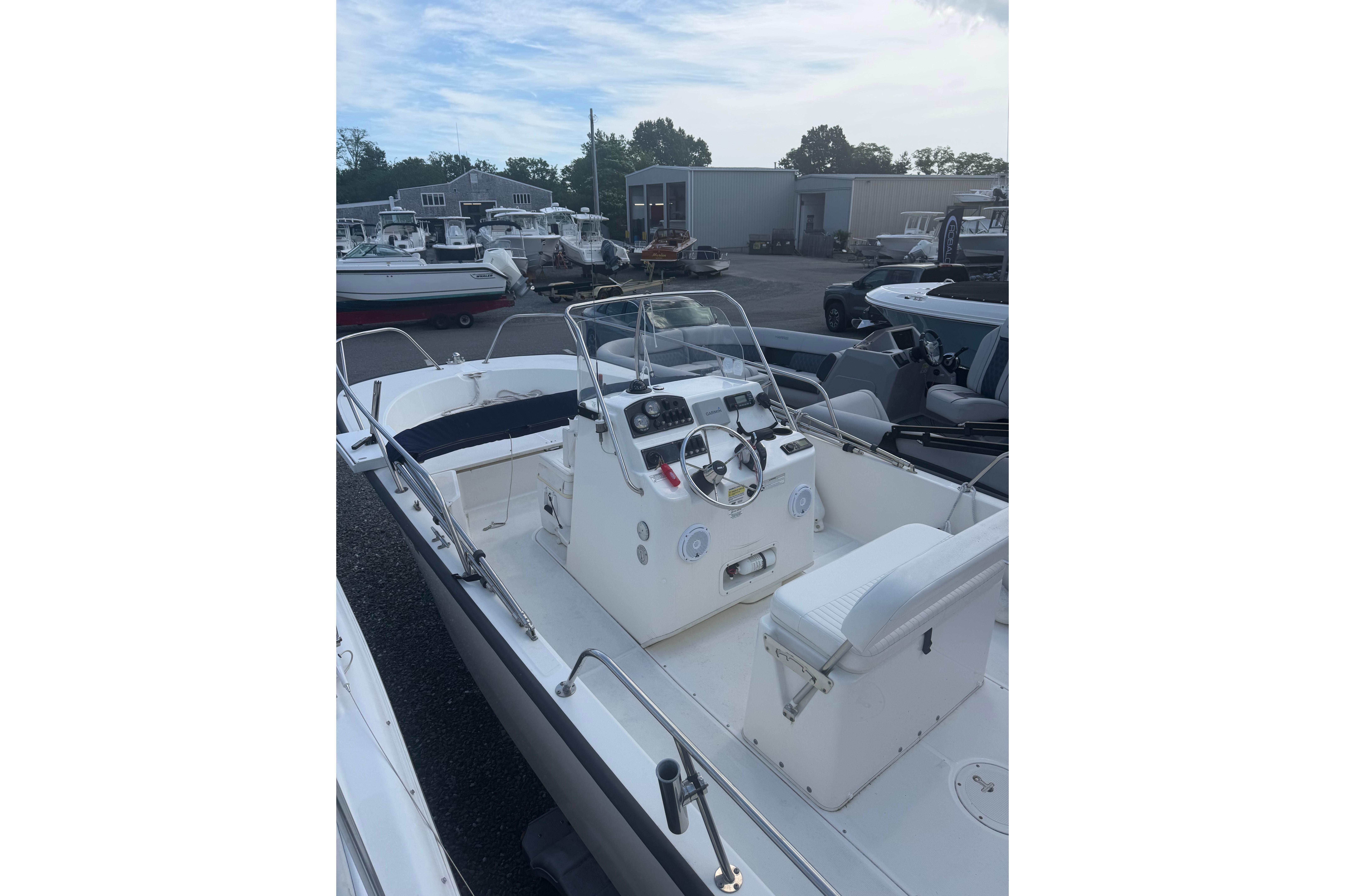 2015 Boston Whaler 210 Montauk boat with center console in a marina setting.