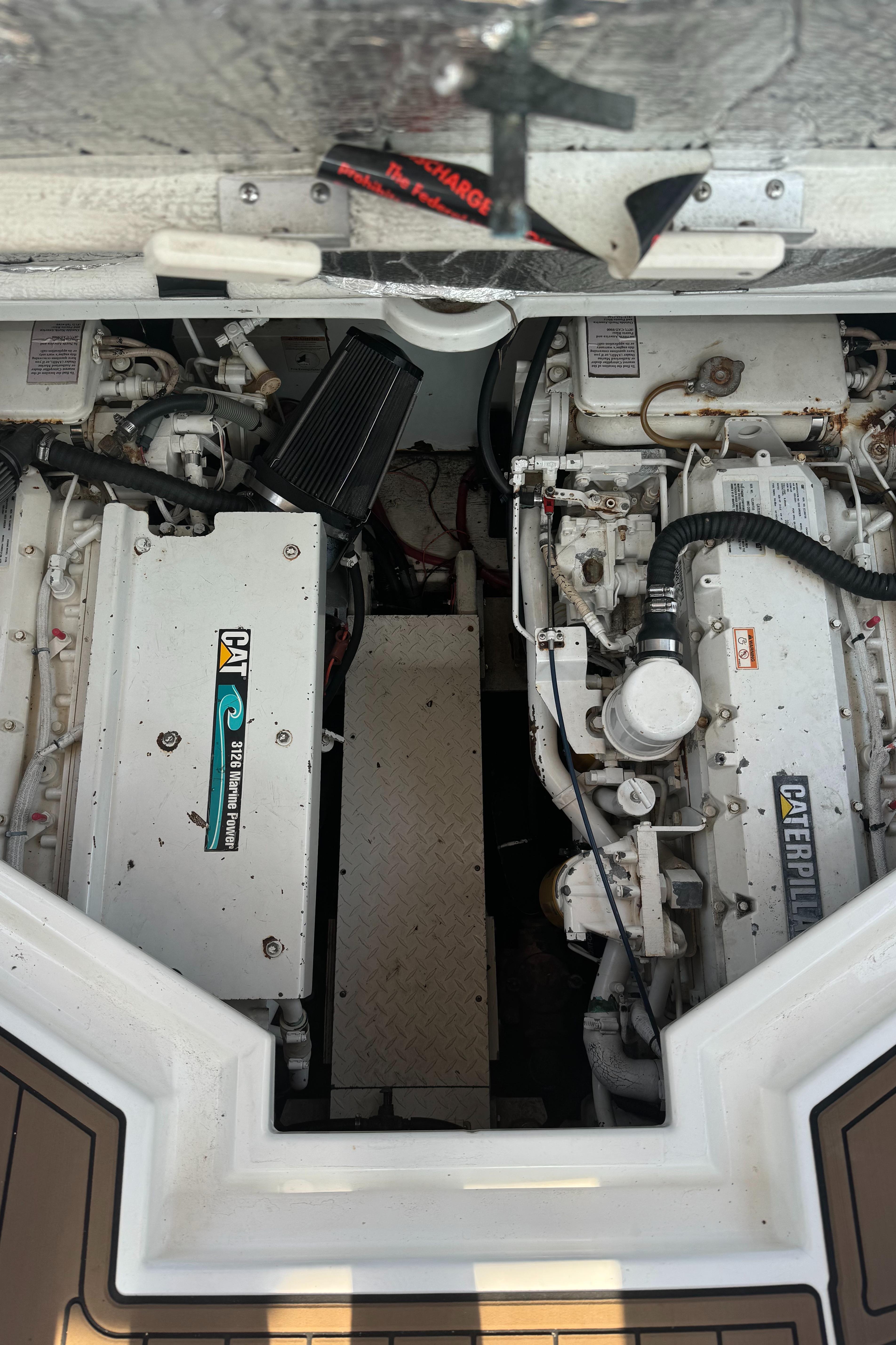 Engine compartment of 2001 Cruisers Yachts 3870 Express with twin Caterpillar engines.