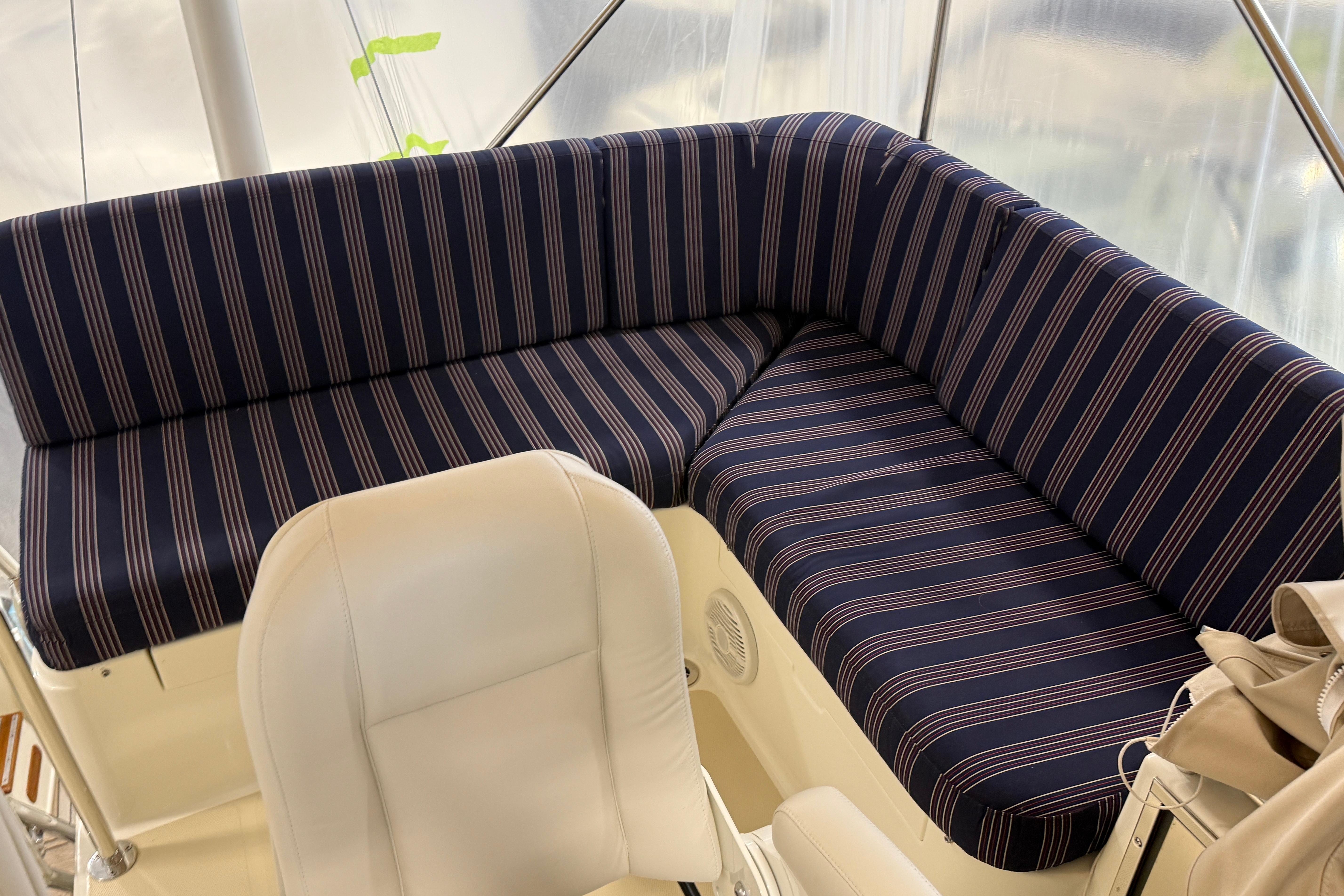 2021 Sabre 42 Fly Bridge interior with striped seating and white chair.