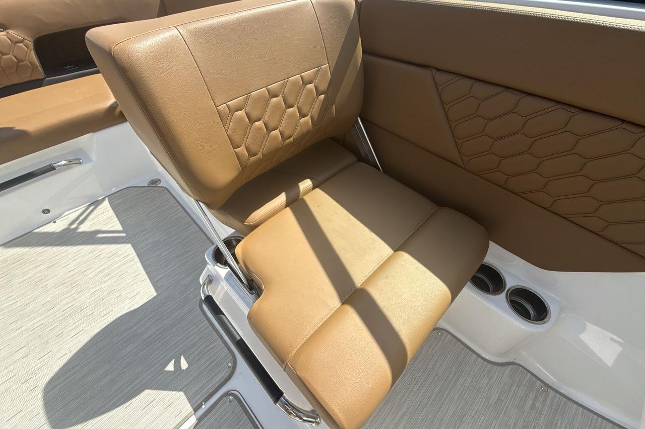 2024 Four Winns H1 OB boat interior with brown leather seating and modern design.