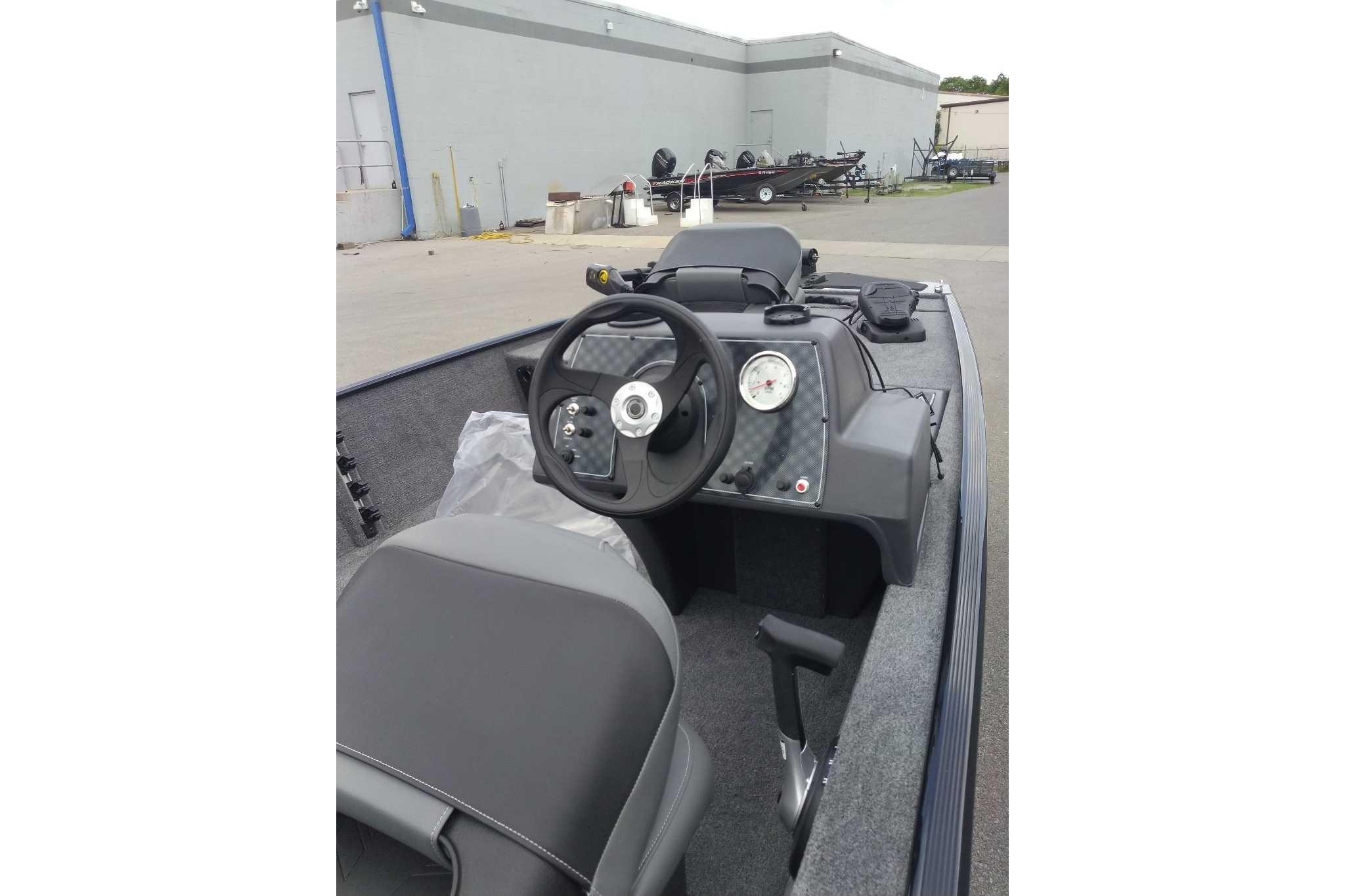 2026 Tracker Bass Tracker Classic XL boat interior with steering wheel and dashboard controls.