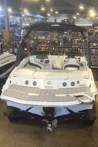2023 Tahoe 210 Si Limited boat displayed in a showroom.