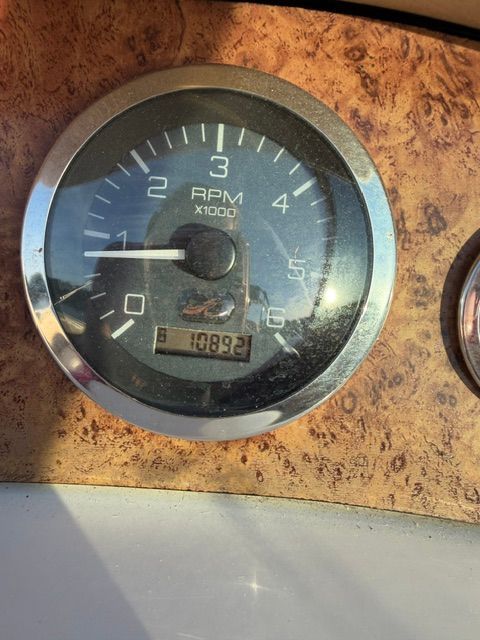A tachometer with wood trim shows 1089.2 RPM.