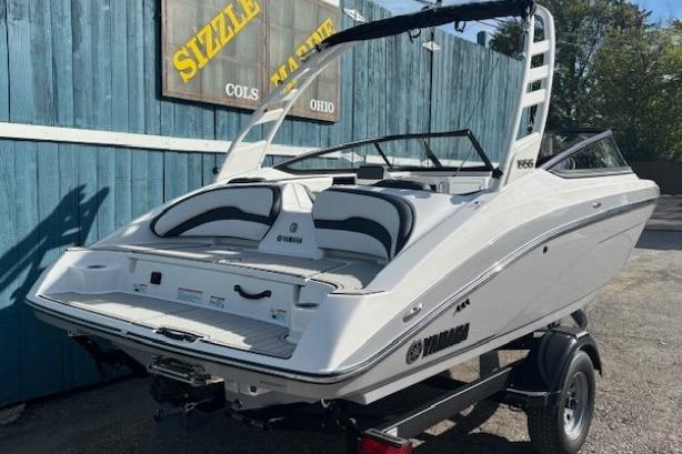2026 Yamaha Boats 195S, sleek white design, parked on trailer, outdoor setting.