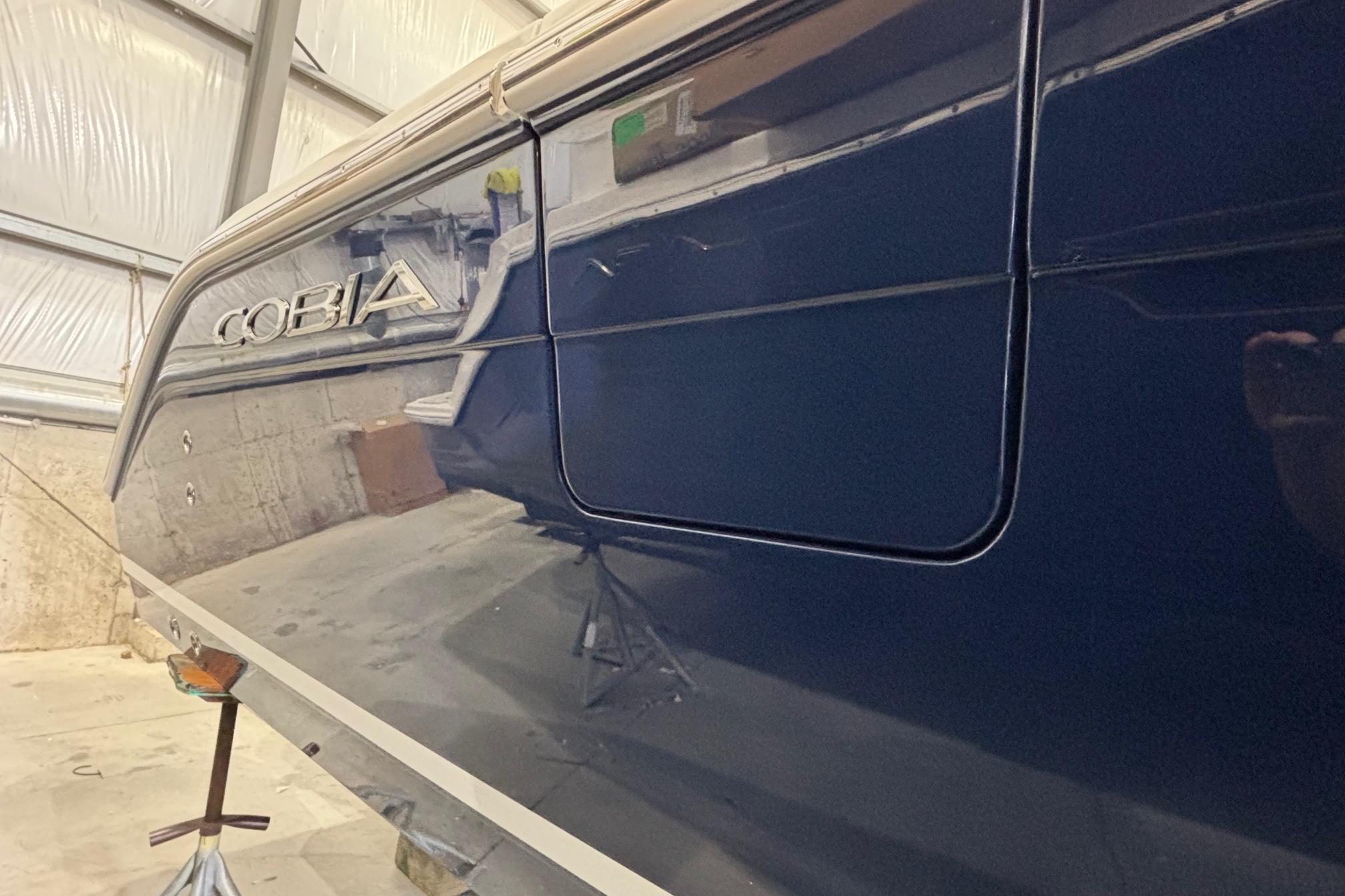 2026 Cobia 285 Open Center Console boat in a storage facility.