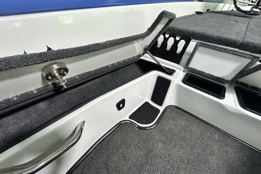 Interior of 2026 Phoenix 818 Pro boat, featuring storage compartments and carpeted flooring.