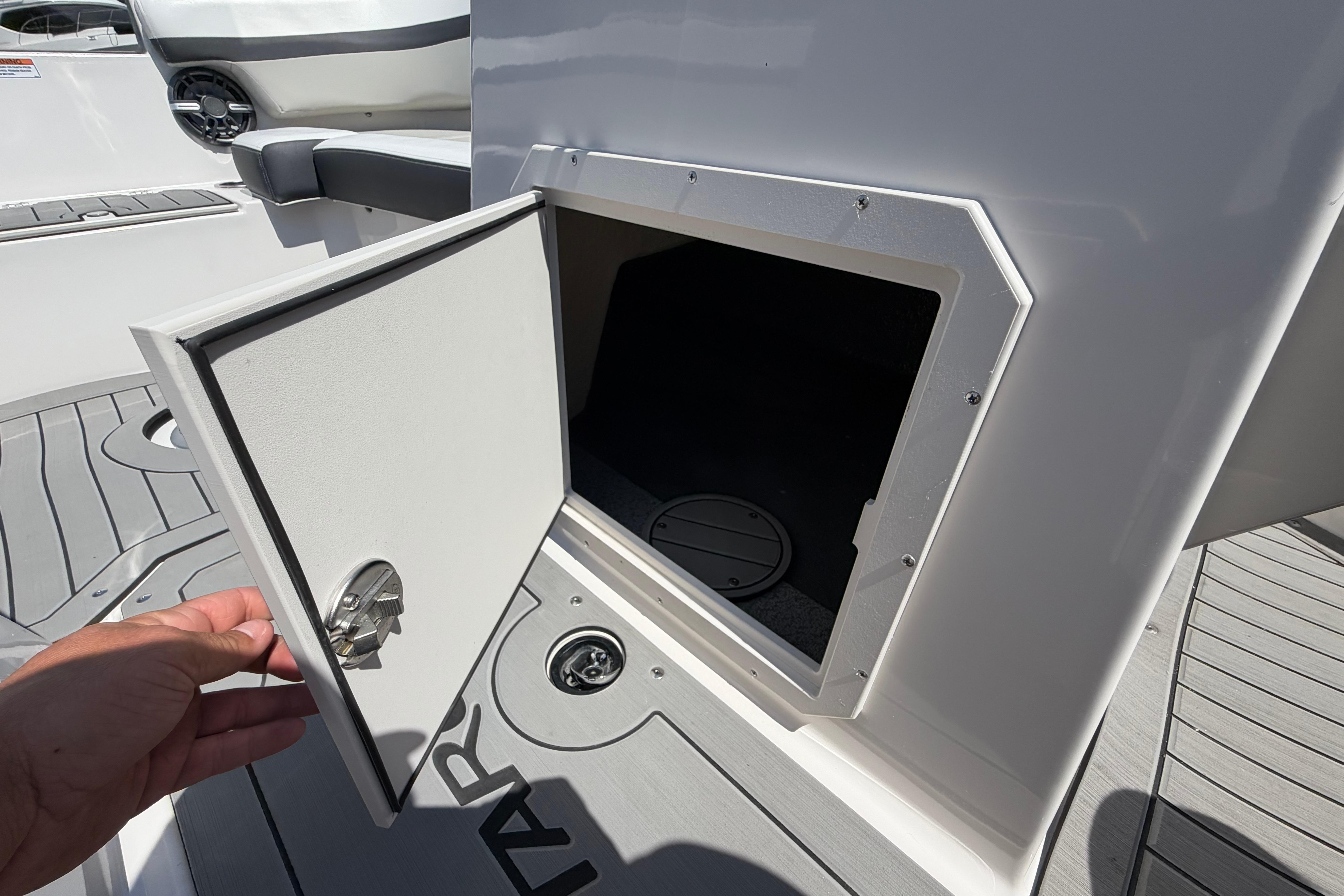 Open storage compartment on 2025 Starcraft SVX 190 OB boat deck.
