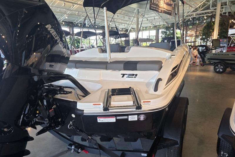 2026 Tahoe T21 boat displayed indoors with Mercury engine, sleek design, and modern features.