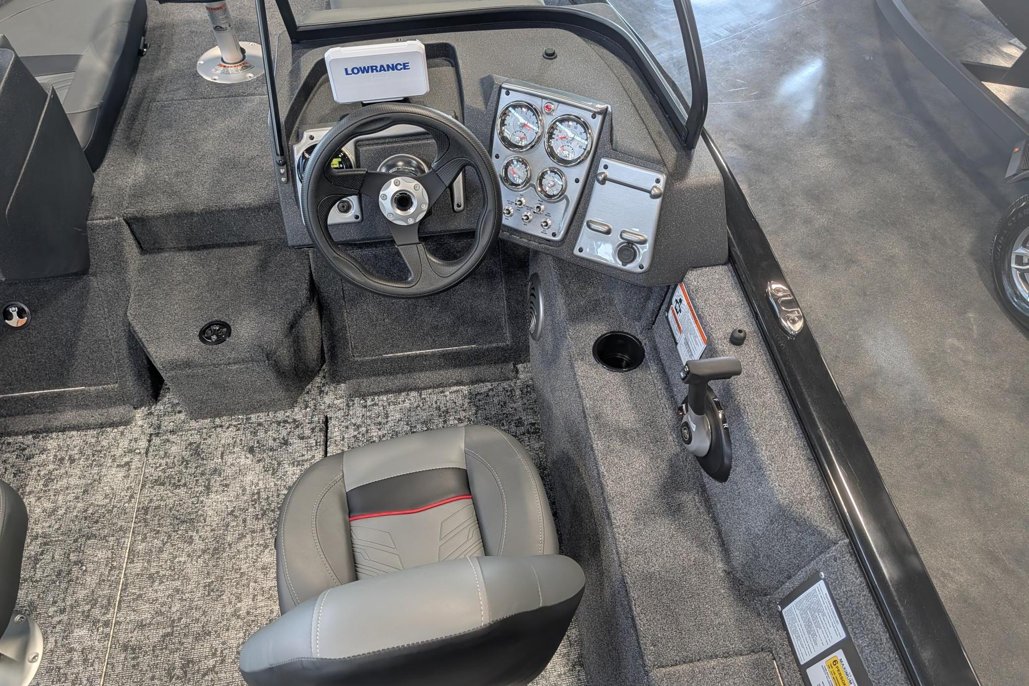 Interior view of 2026 Tracker Pro Guide V-175 Combo boat cockpit with steering wheel and controls.