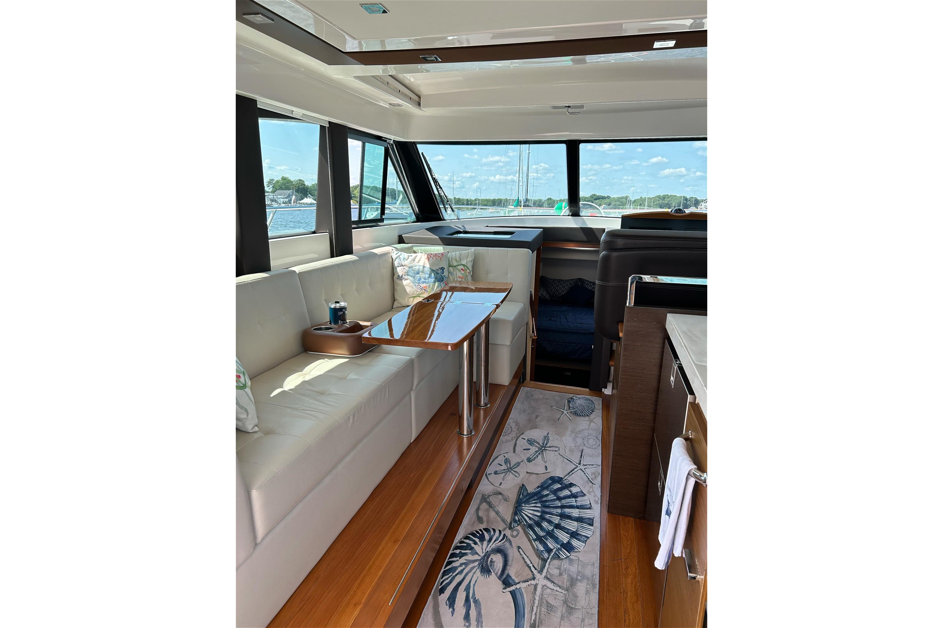 Luxurious interior of 2017 Tiara Yachts C39 Coupe with elegant seating and panoramic windows.