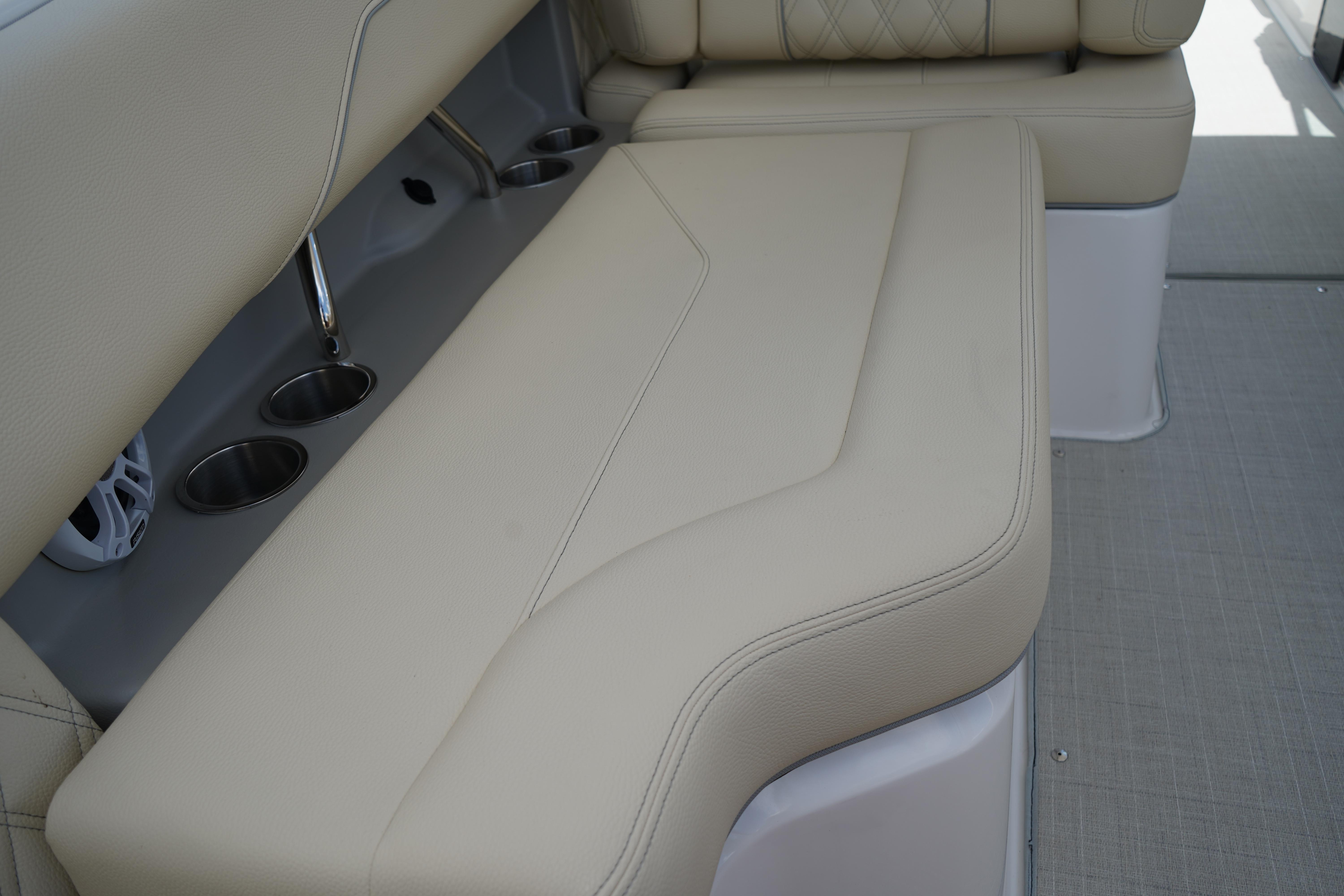 2023 Regal LX4 boat interior with beige seating and cup holders.