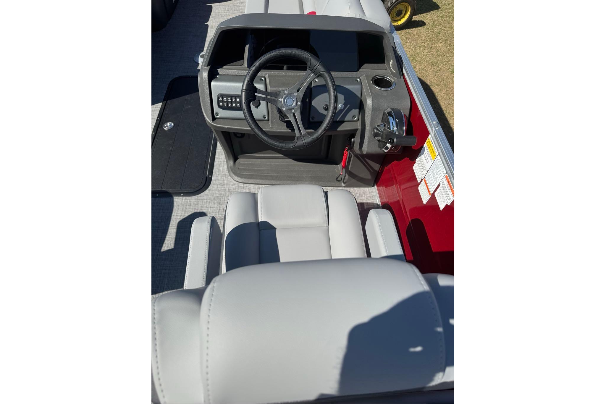 Interior view of 2026 Sun Tracker Party Barge 22 XP3, featuring steering console and seating.