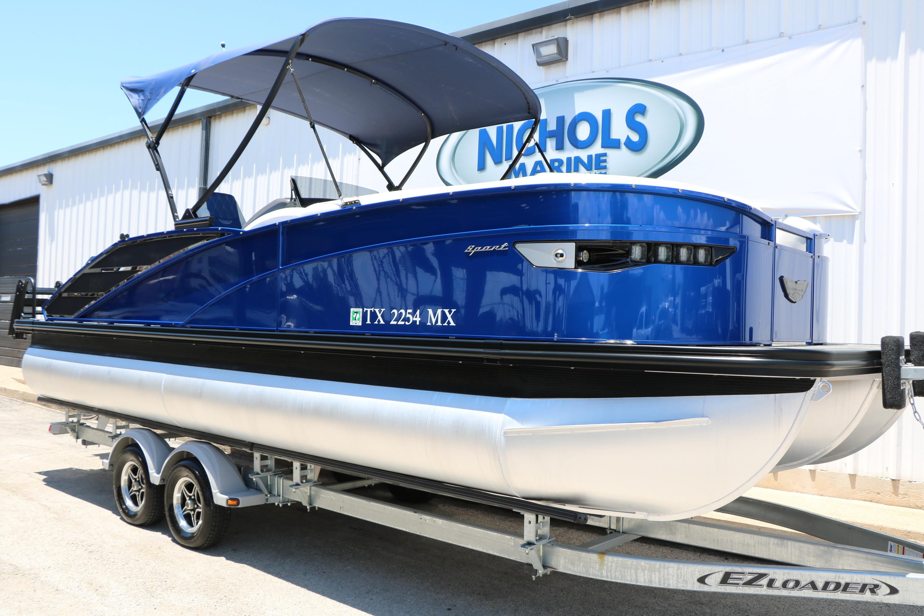 2024 Bennington 23 RX Swingback pontoon boat on trailer at Nichols Marine.