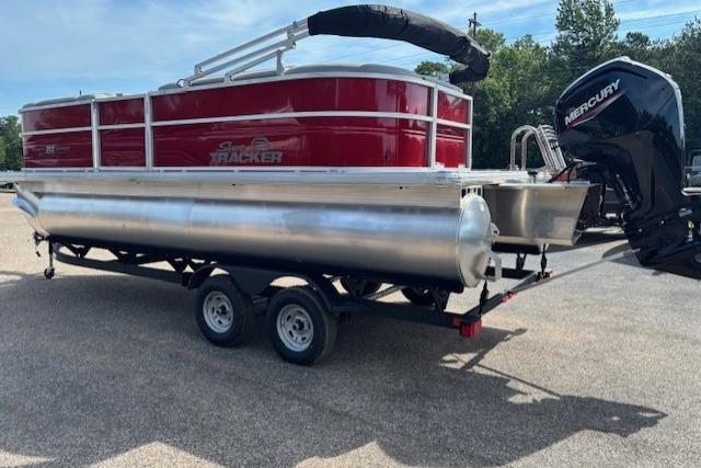 2026 Sun Tracker Party Barge 20 DLX pontoon boat with Mercury outboard motor on trailer.