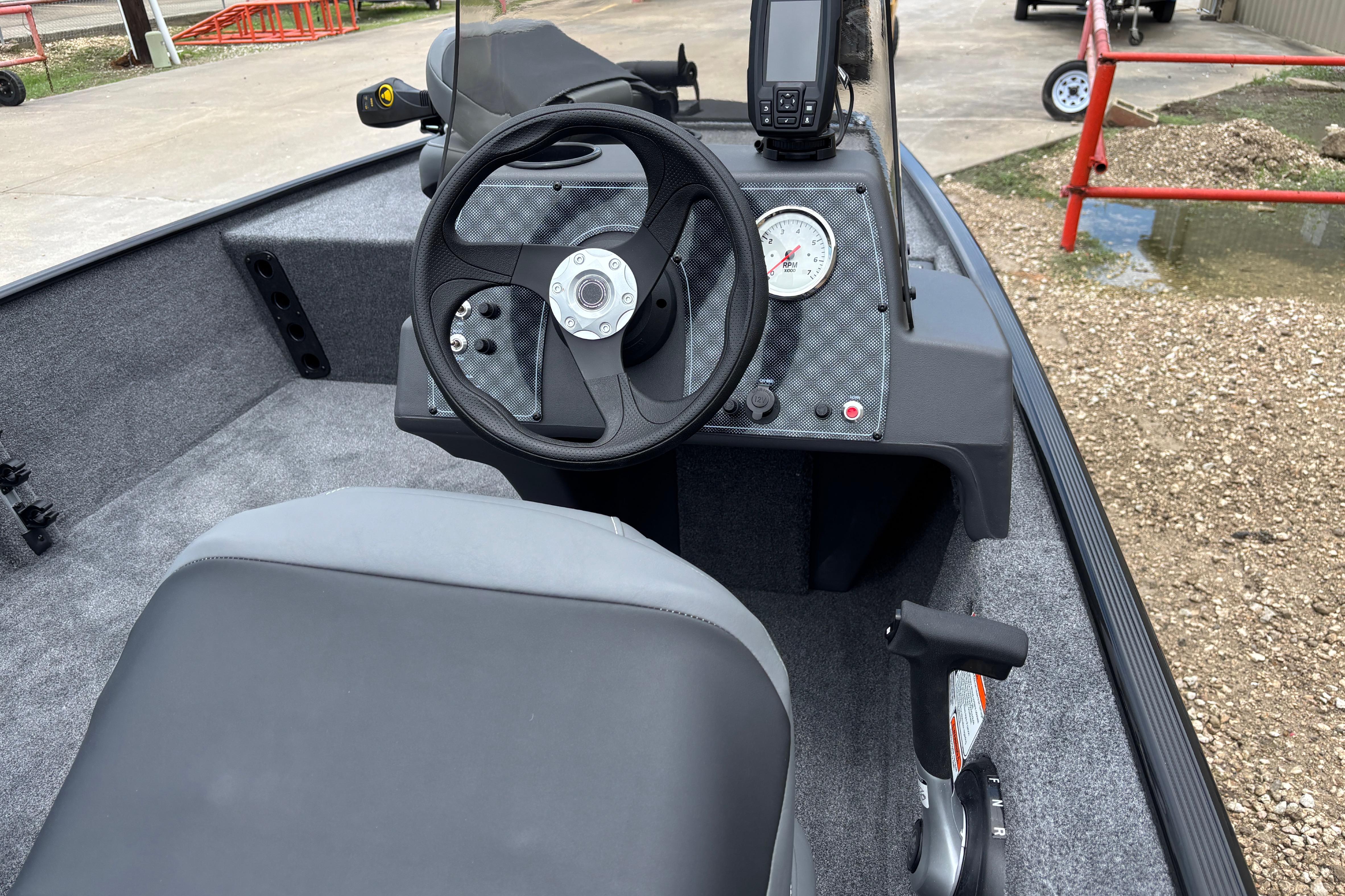2026 Tracker Bass Tracker Classic XL boat interior with steering wheel and dashboard controls.